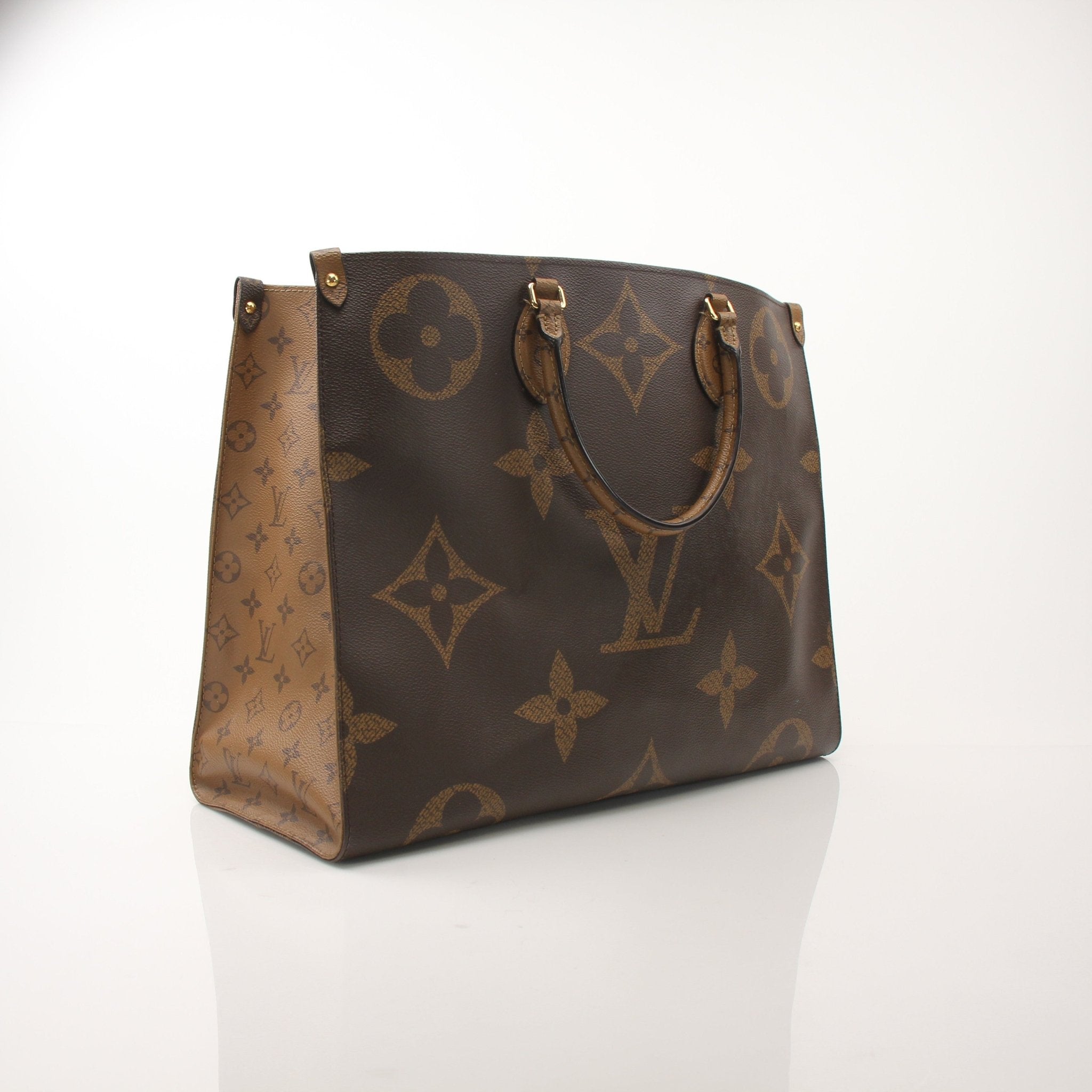 Louis Vuitton OnTheGo Reverse MM handbag in brown and beige leather with gold hardware and dual top handles.
