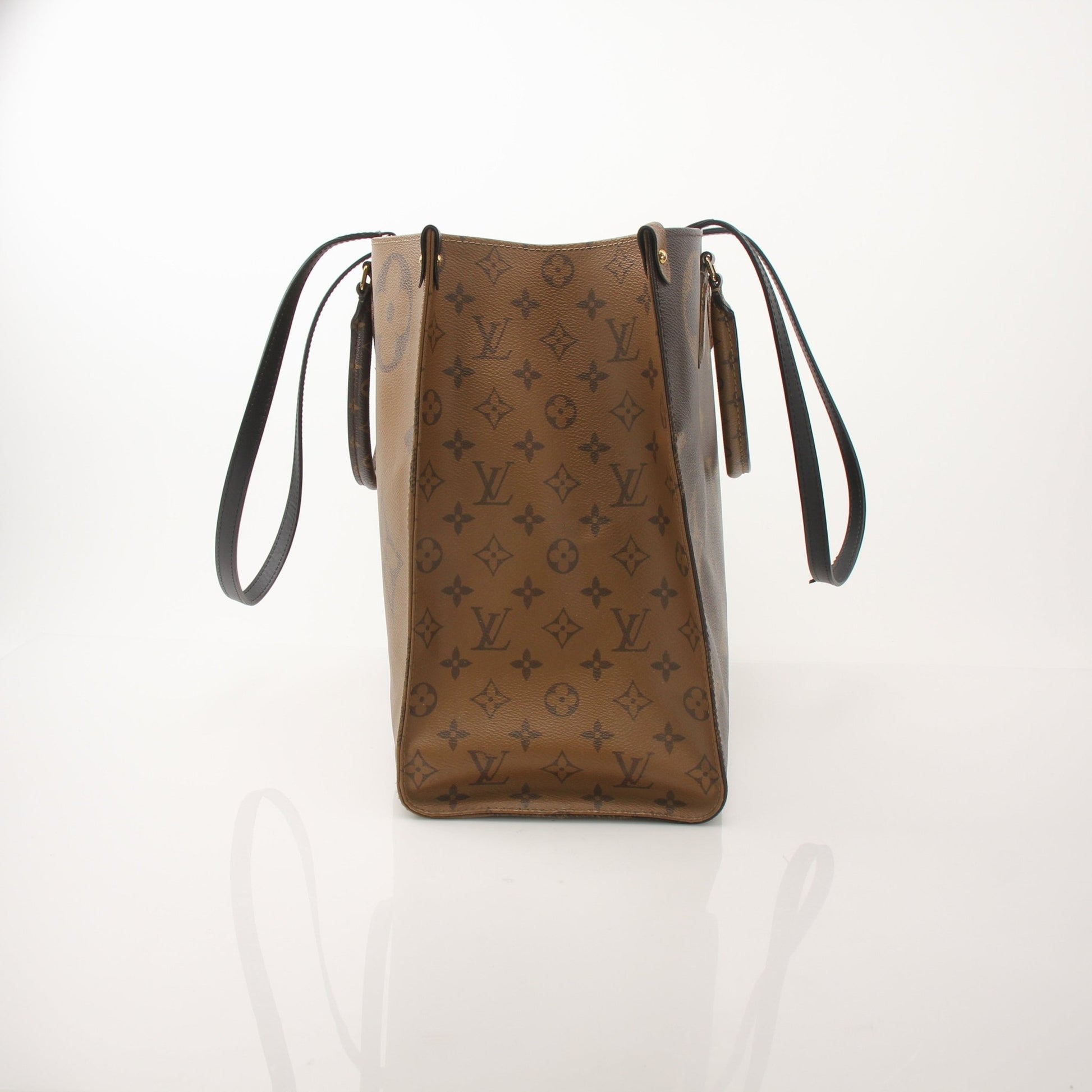 Louis Vuitton OnTheGo Reverse MM handbag in brown and tan leather with gold hardware, displayed on a neutral background.