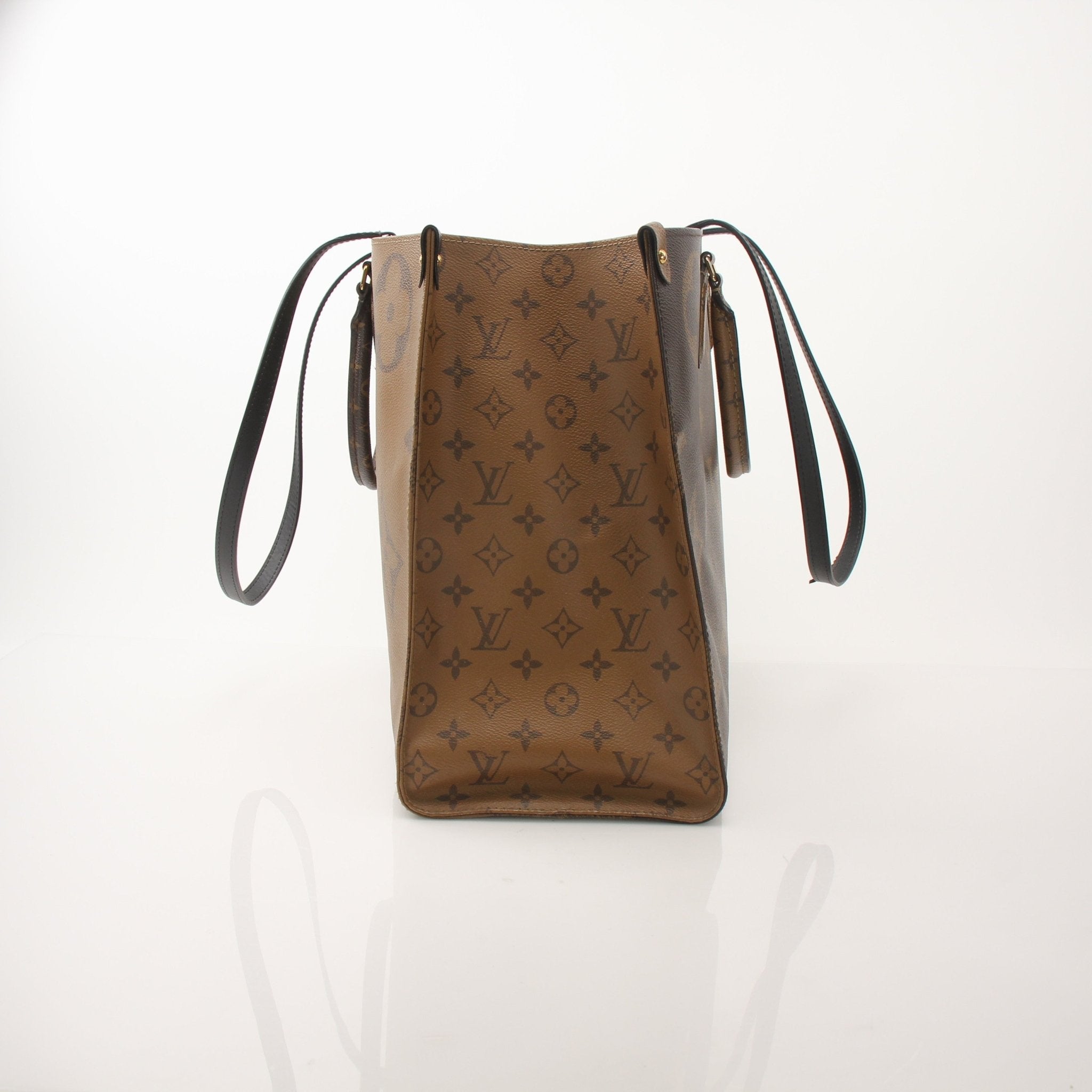 Louis Vuitton OnTheGo Reverse MM handbag in brown and tan leather with gold hardware, displayed on a neutral background.
