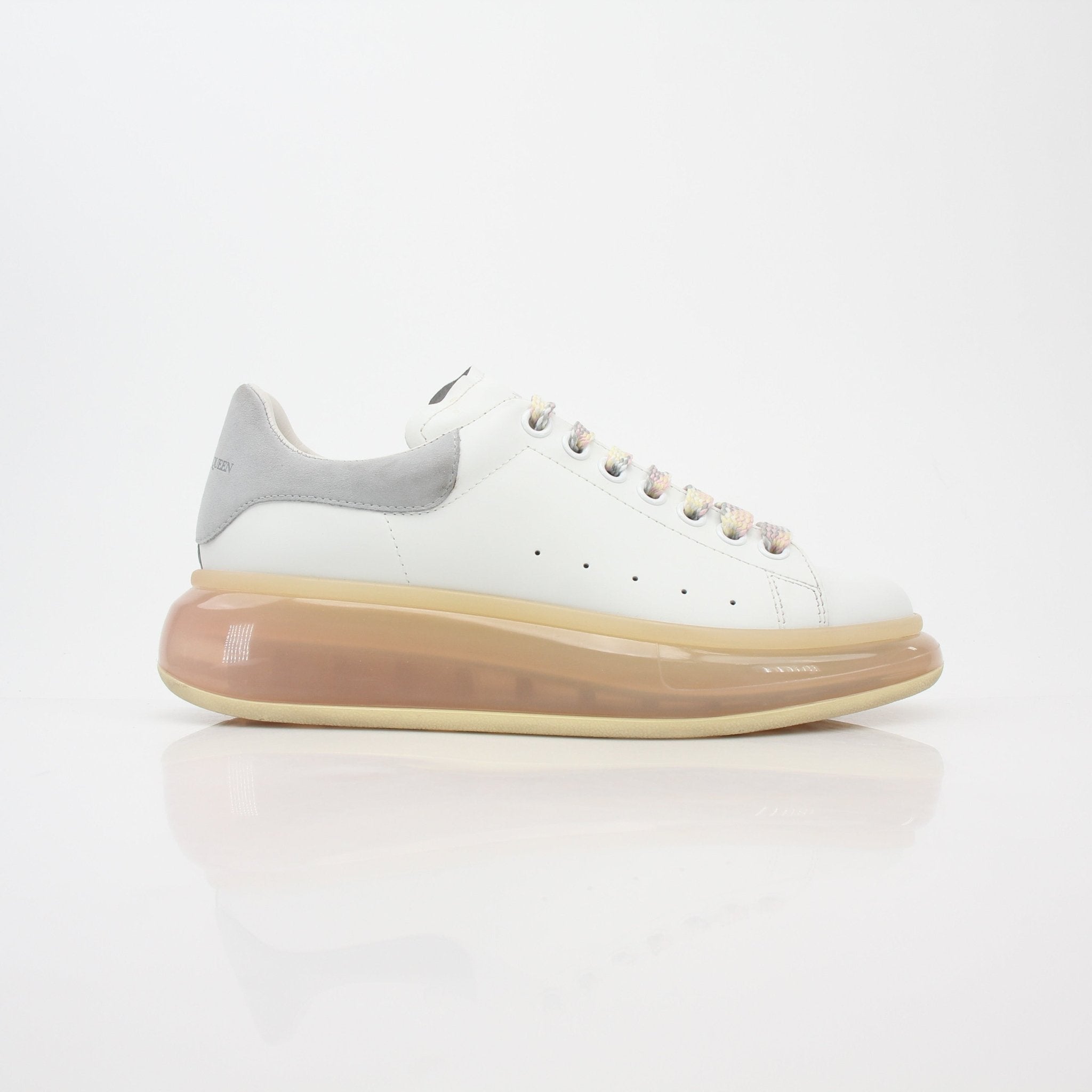 Alexander McQueen white oversized transparent-sole sneakers with chunky design and branding, stylish shoes by Gold & Beyond.