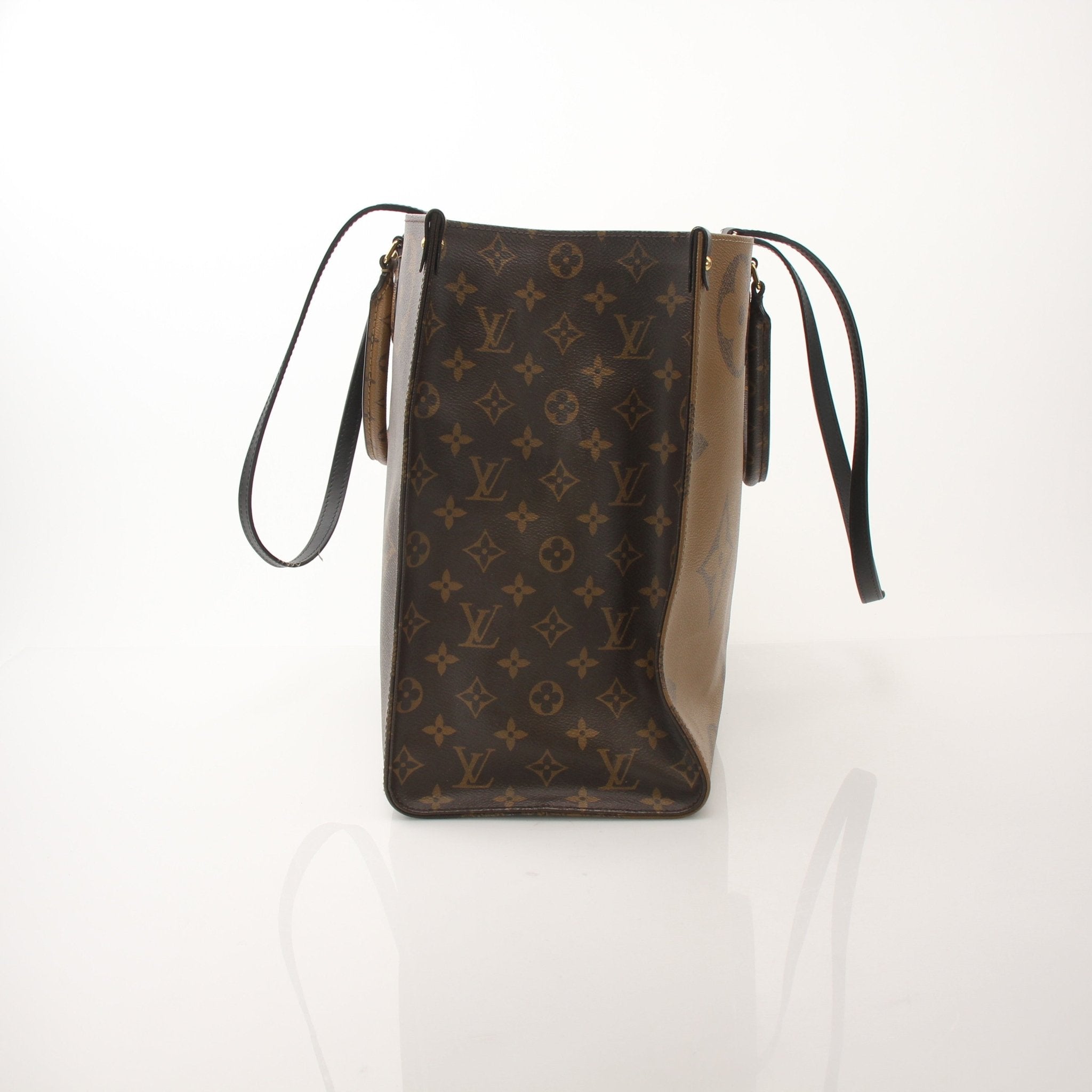 Louis Vuitton OnTheGo Reverse MM handbag with gold-tone hardware and spacious design, featuring signature monogram canvas and leather accents.