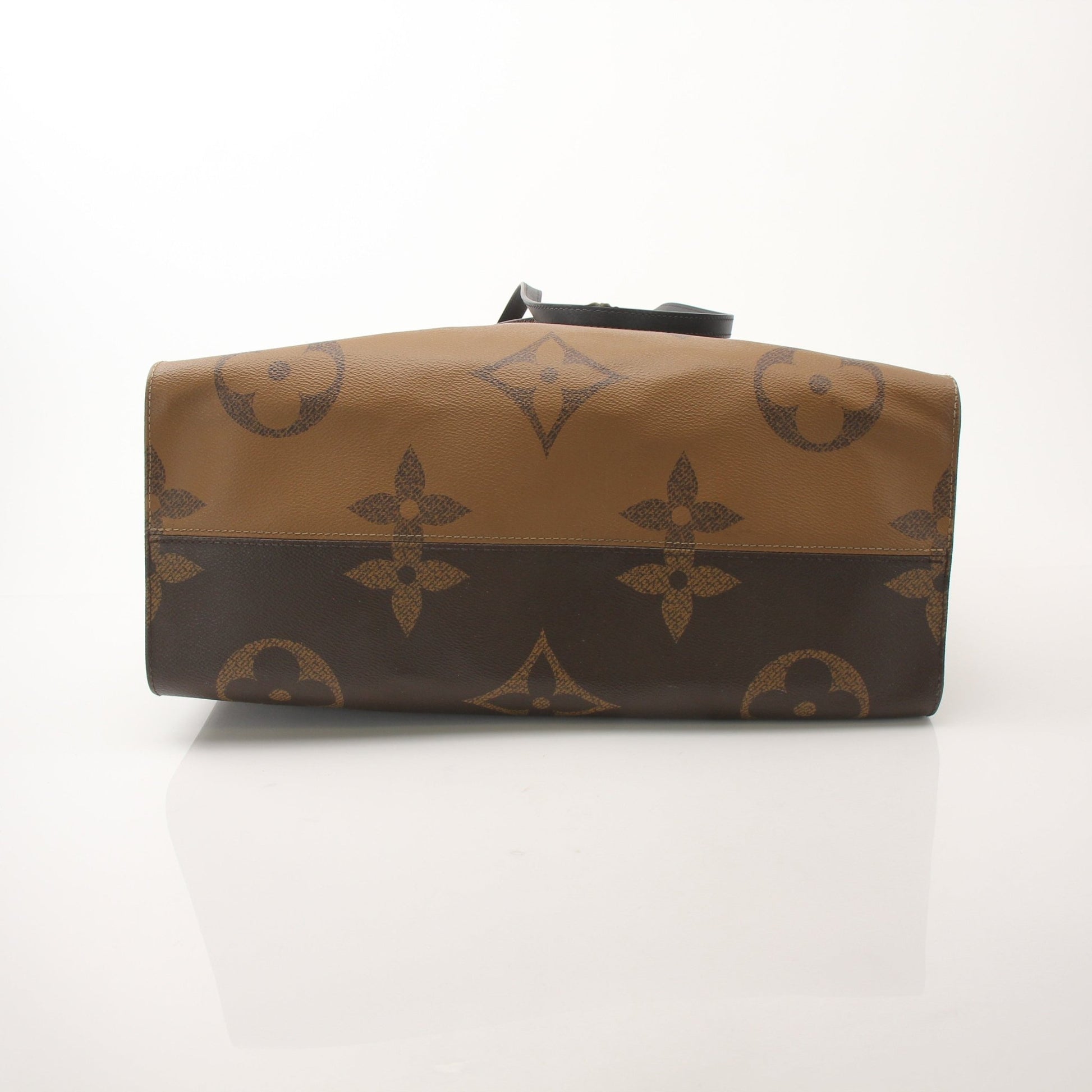 Louis Vuitton OnTheGo Reverse MM handbag with gold hardware, featuring monogram canvas and reverse pattern, displayed on a plain background.
