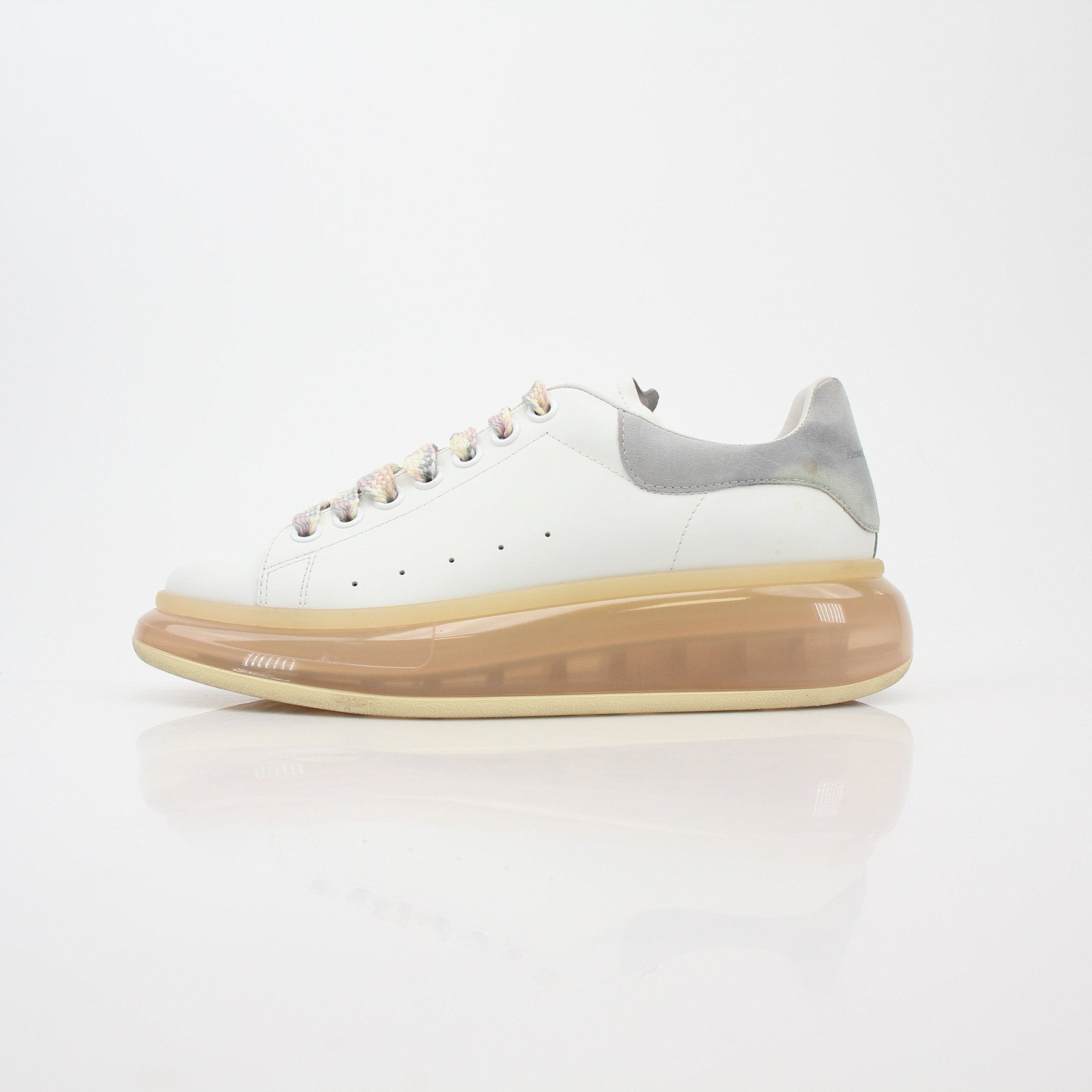 Alexander McQueen white oversized transparent-sole sneakers featuring a sleek design and clear sole, perfect for modern casual wear.