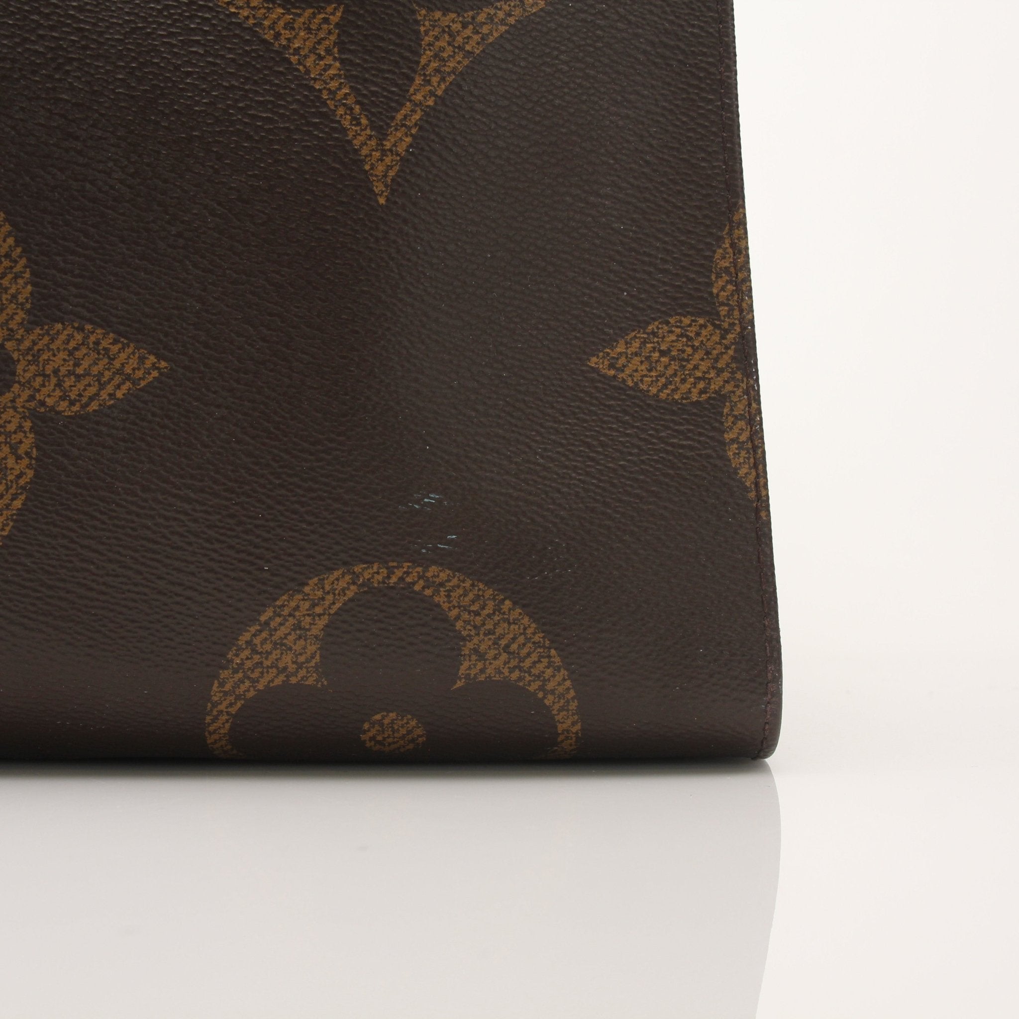 Louis Vuitton OnTheGo Reverse MM handbag in gold and brown leather with top handles and spacious interior.