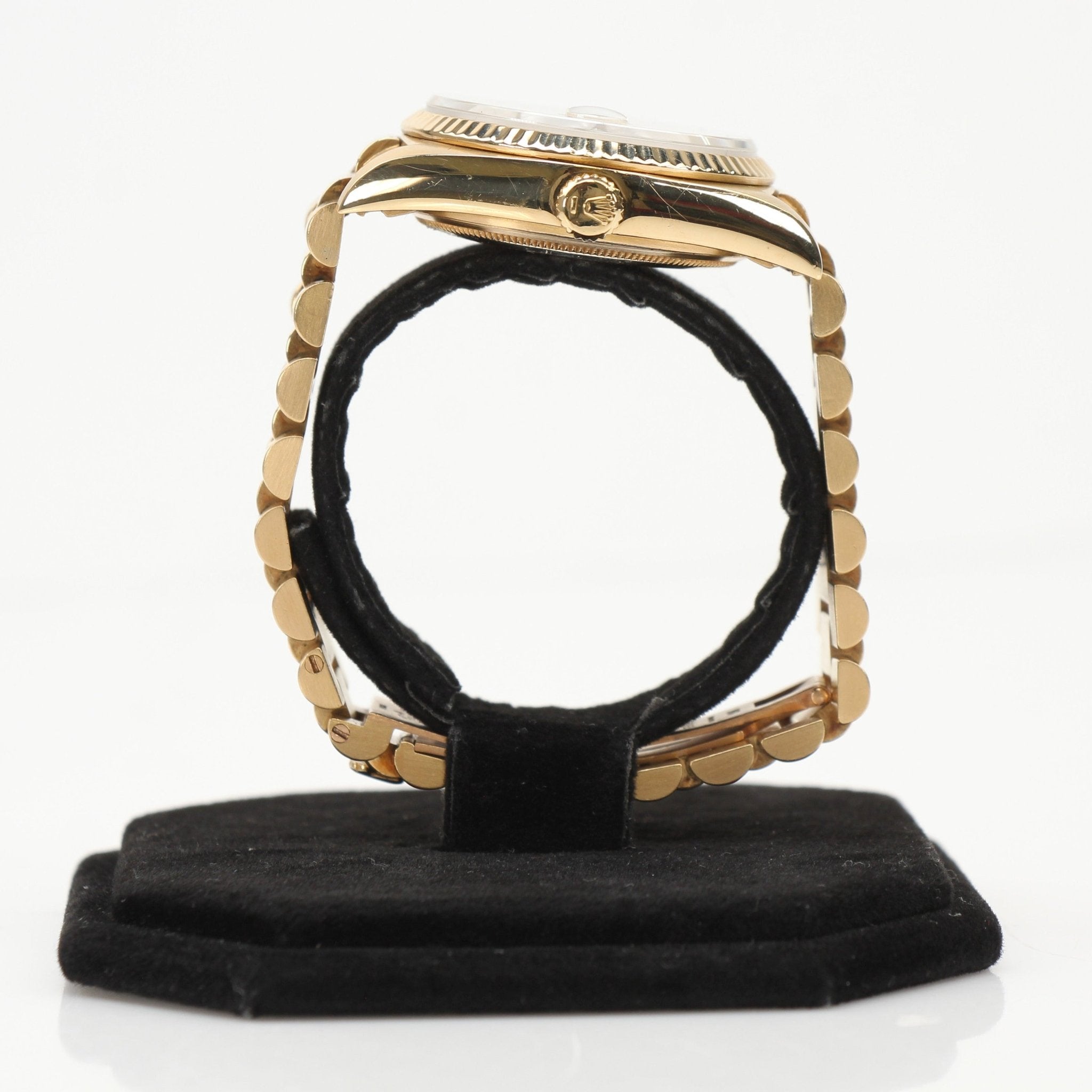 Rolex Day-Date 36 gold watch with gold bracelet and classic dial, displayed on a neutral background.