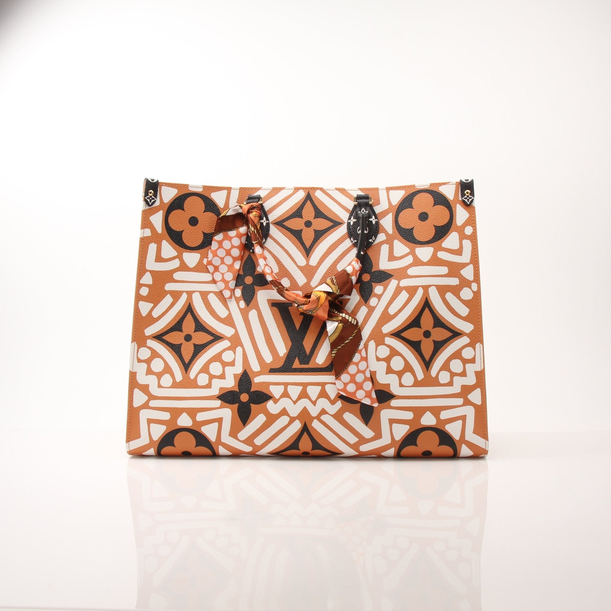 Louis Vuitton OnTheGo Crafty GM tote handbag with gold-tone hardware and textured leather, showcasing spacious interior and stylish design