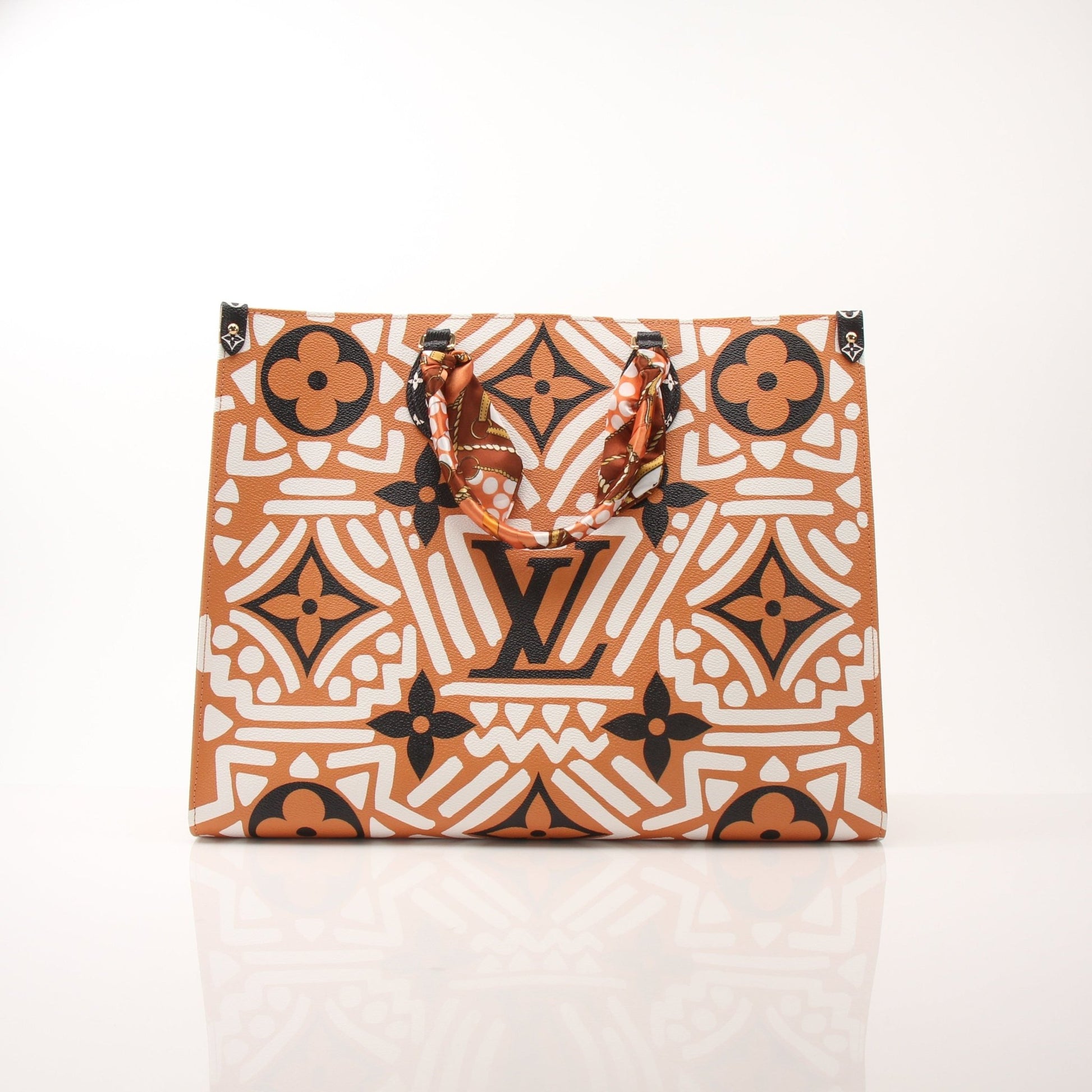 Louis Vuitton OnTheGo Crafty GM tote handbag in brown leather with gold hardware and top handles, displayed against a light background.