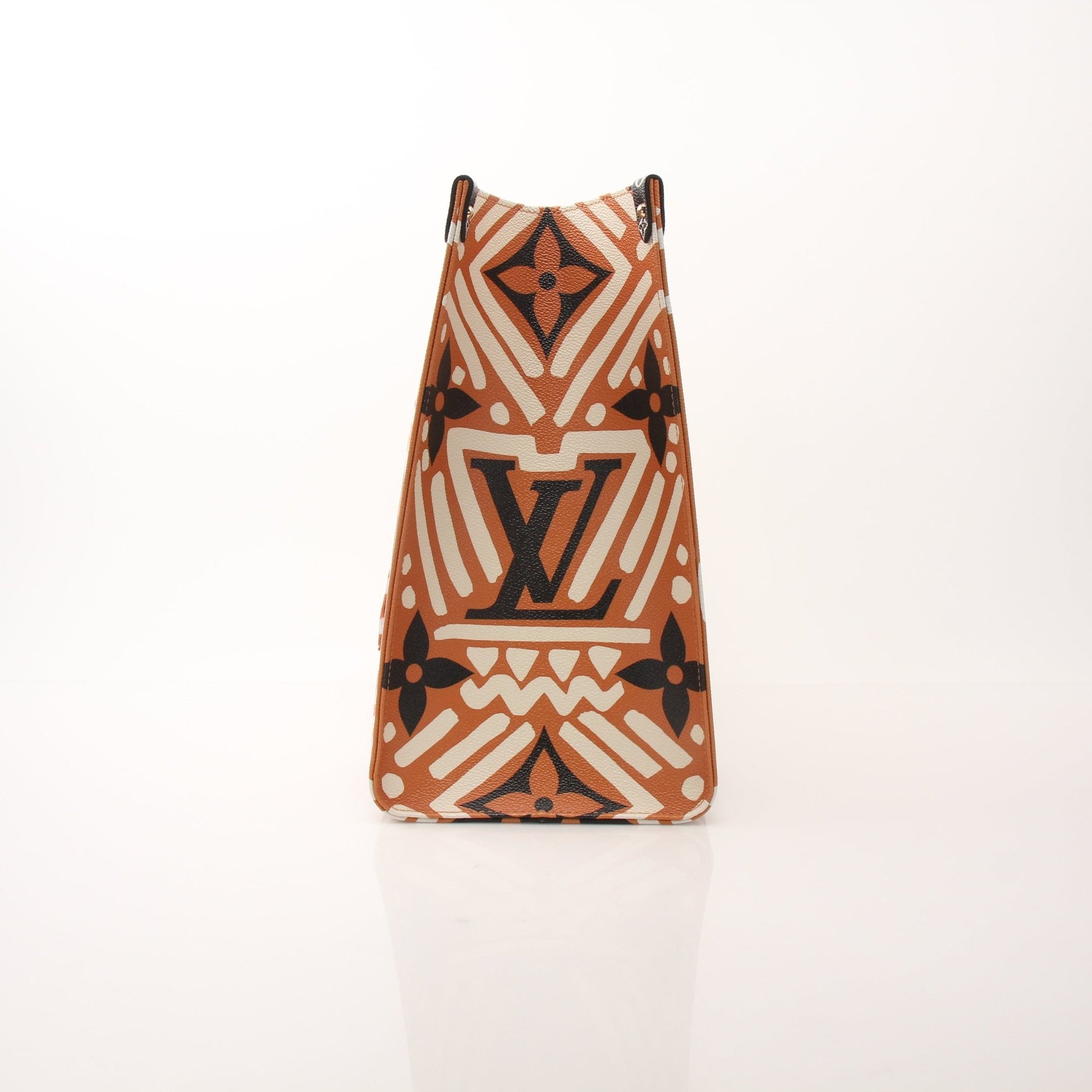 Louis Vuitton OnTheGo Crafty GM tote handbag with beige and brown pattern, gold hardware, and leather handles.