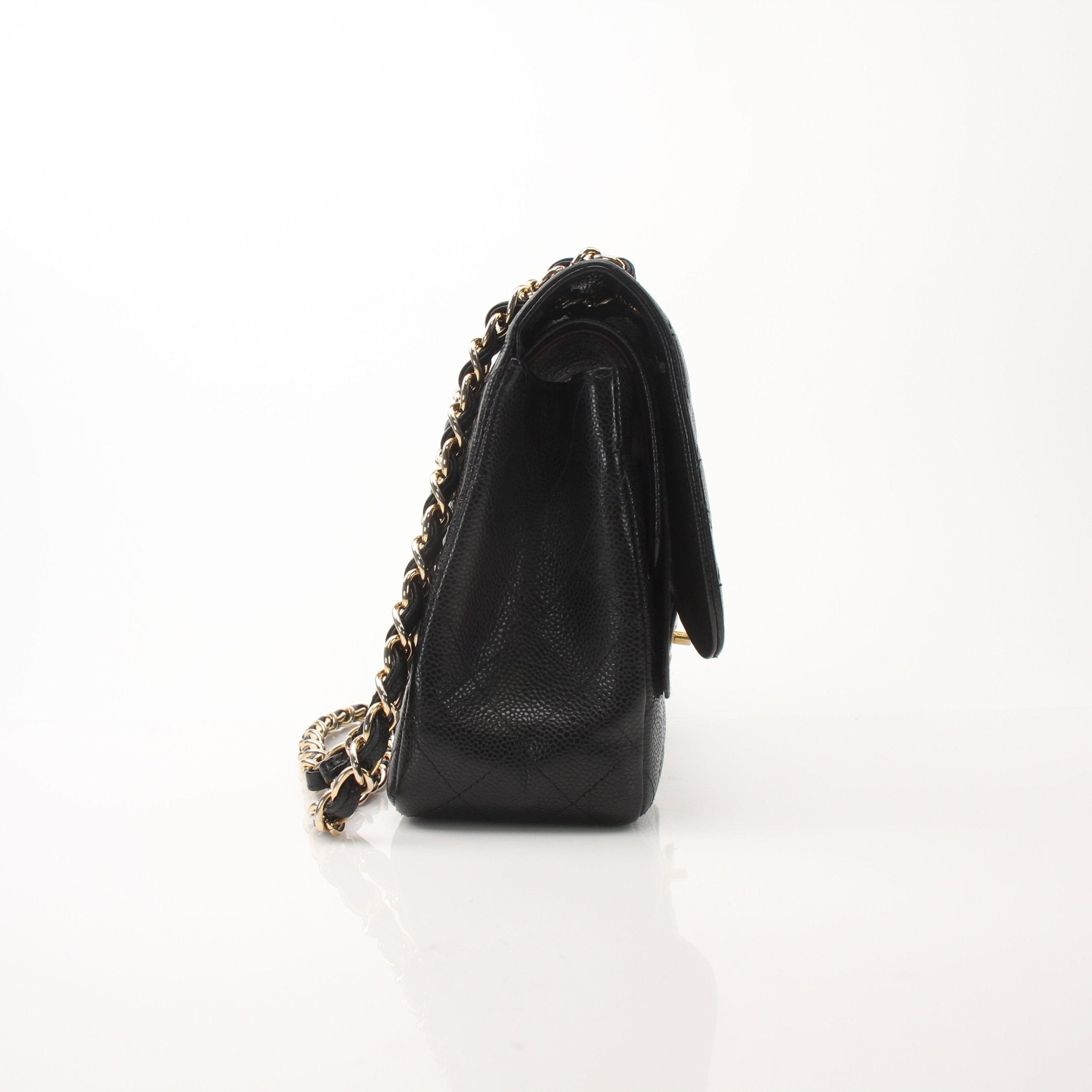 Gold & Beyond Chanel large classic black flap shoulder handbag with gold hardware and quilted leather design.