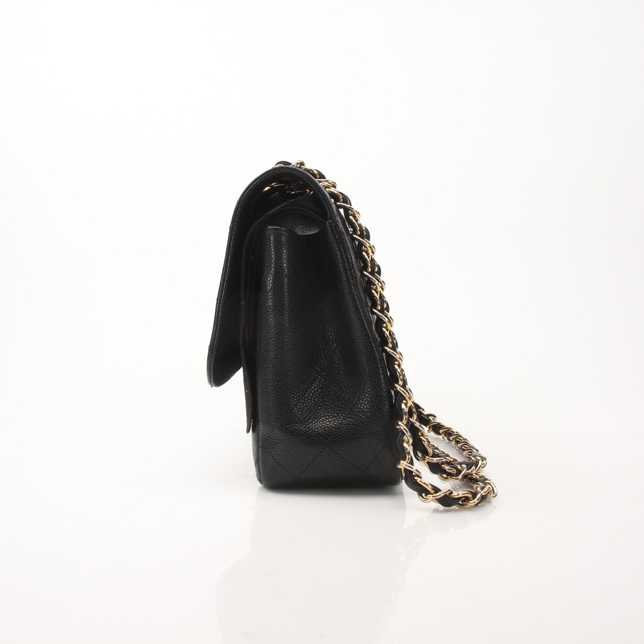 Chanel large classic black shoulder handbag with gold hardware and quilted leather design.