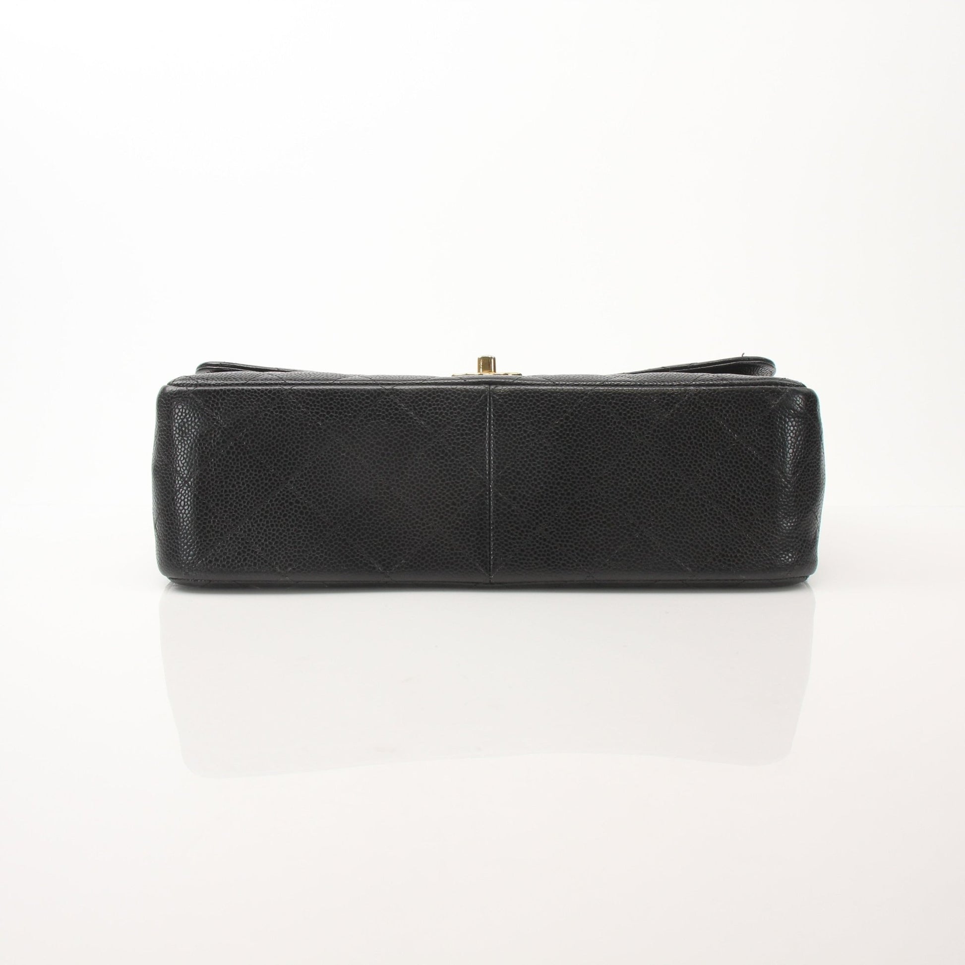 Large black Chanel Classic Flap handbag with gold chain strap and quilted leather, stylish shoulder bag for women.