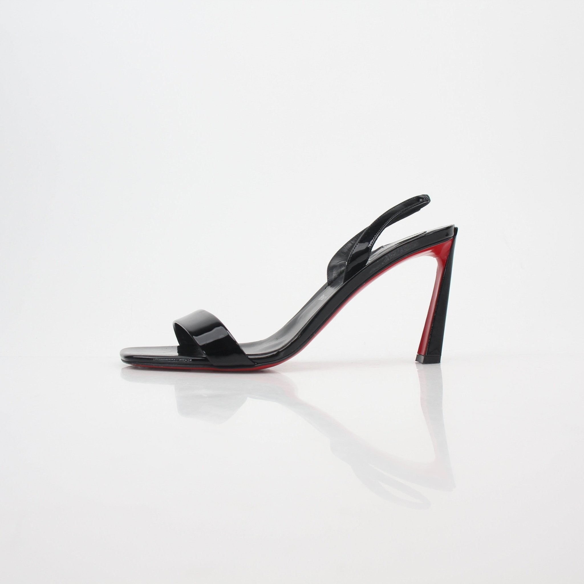 Black Christian Louboutin Condora Queen patent leather heels with pointed toes and sleek design, shown on a neutral background.