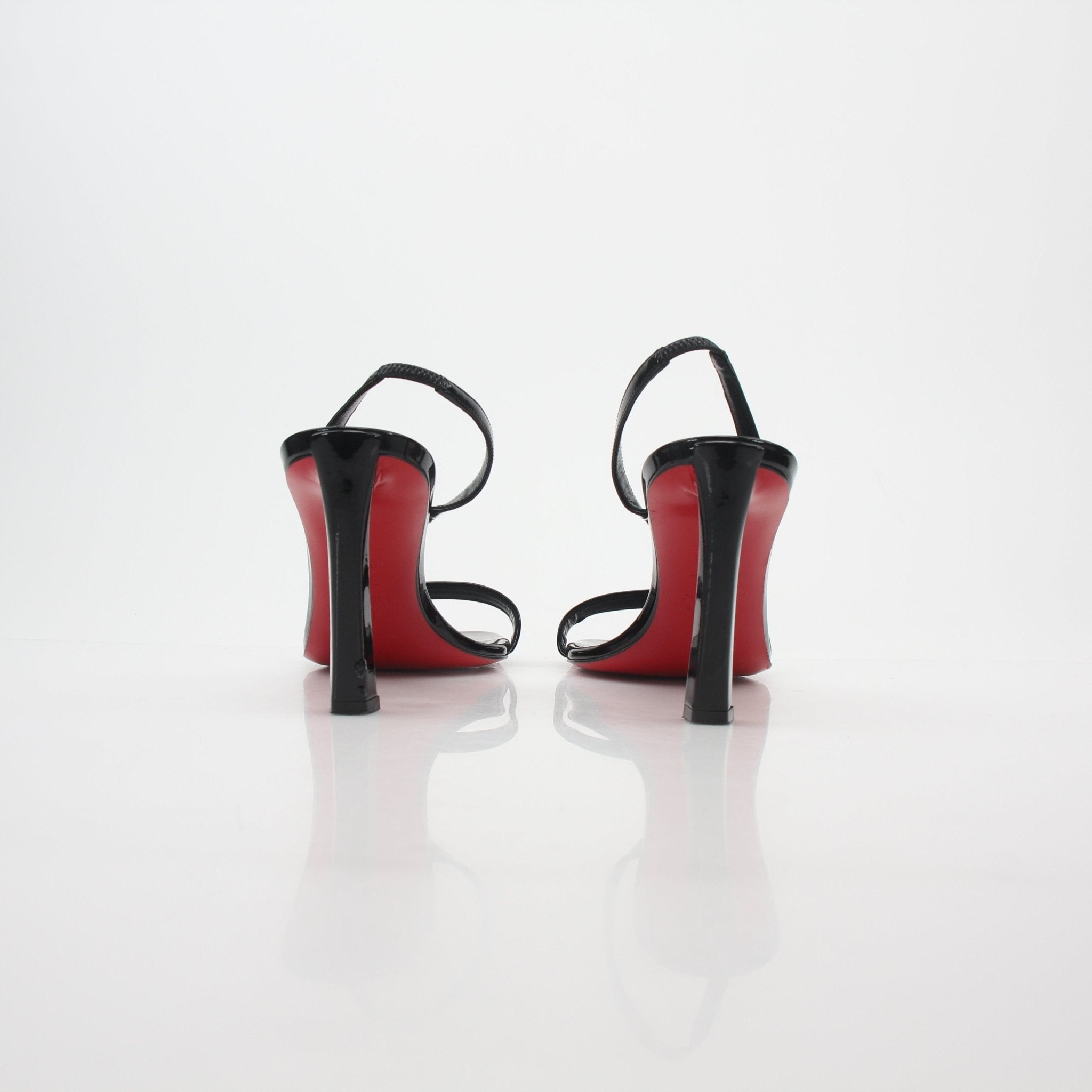 Christian Louboutin Black Condora Queen patent leather sandals with stiletto heels, featuring sleek design and signature red sole.