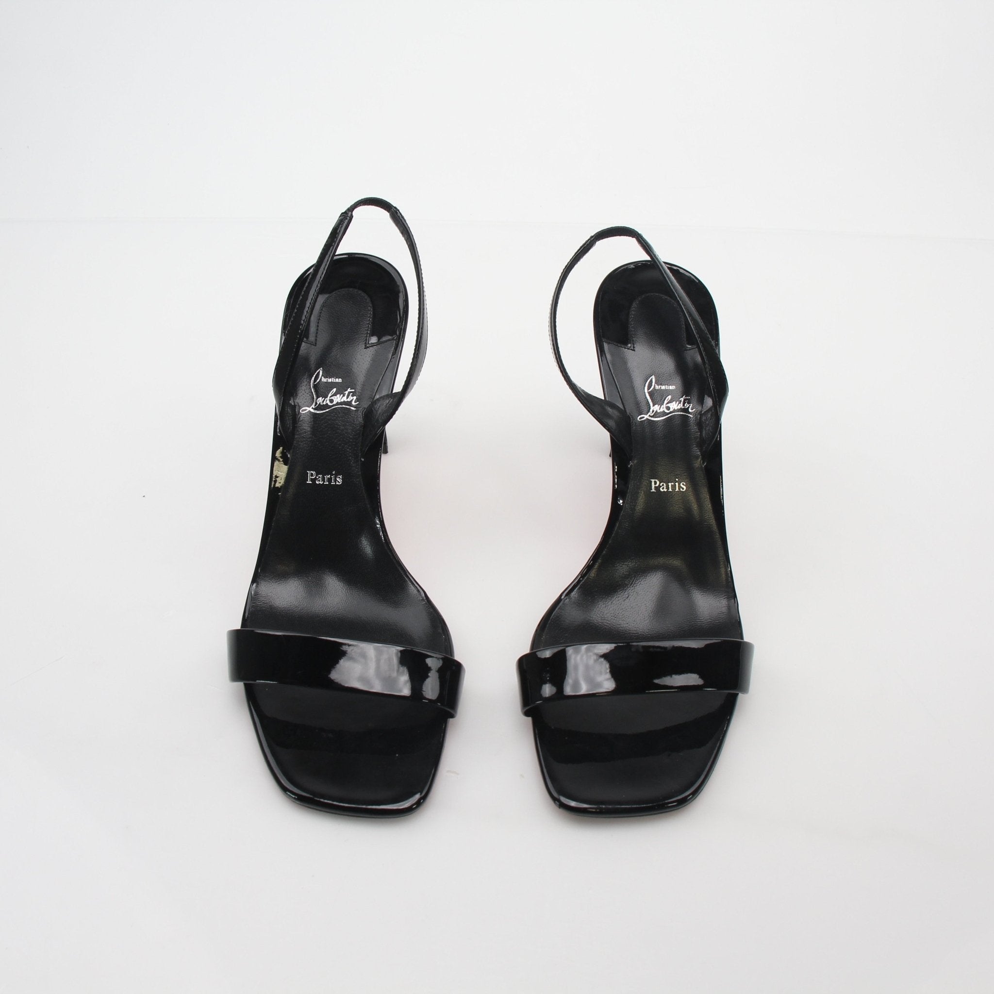 Black Christian Louboutin Condora Queen patent leather sandals with high heels and elegant strap design.