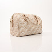 Louis Vuitton Speedy Bandoulière handbag with gold hardware and monogram canvas, featuring a top handle and adjustable shoulder strap.