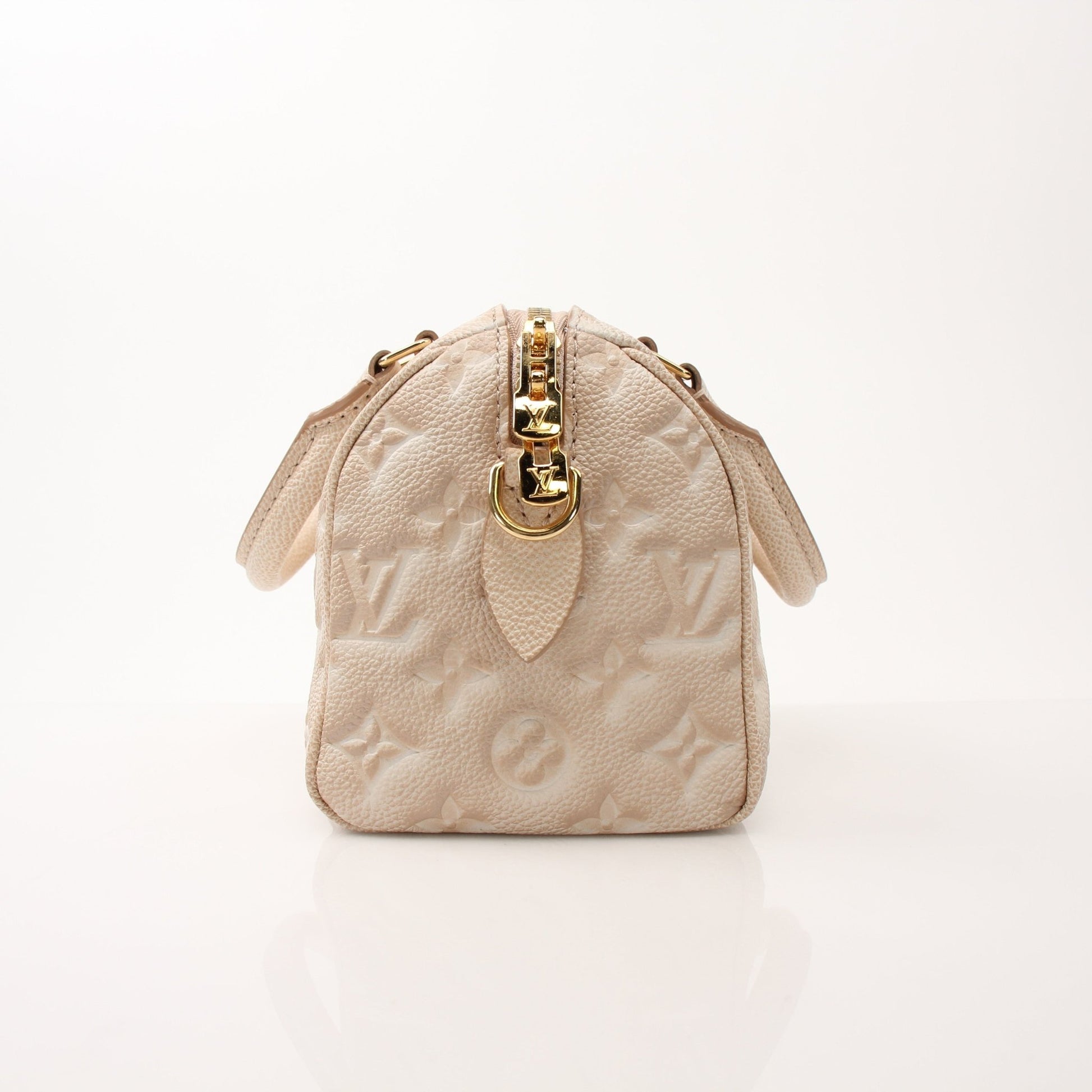 Louis Vuitton Speedy Bandoulière handbag with gold hardware and leather handles, featuring signature monogram canvas.