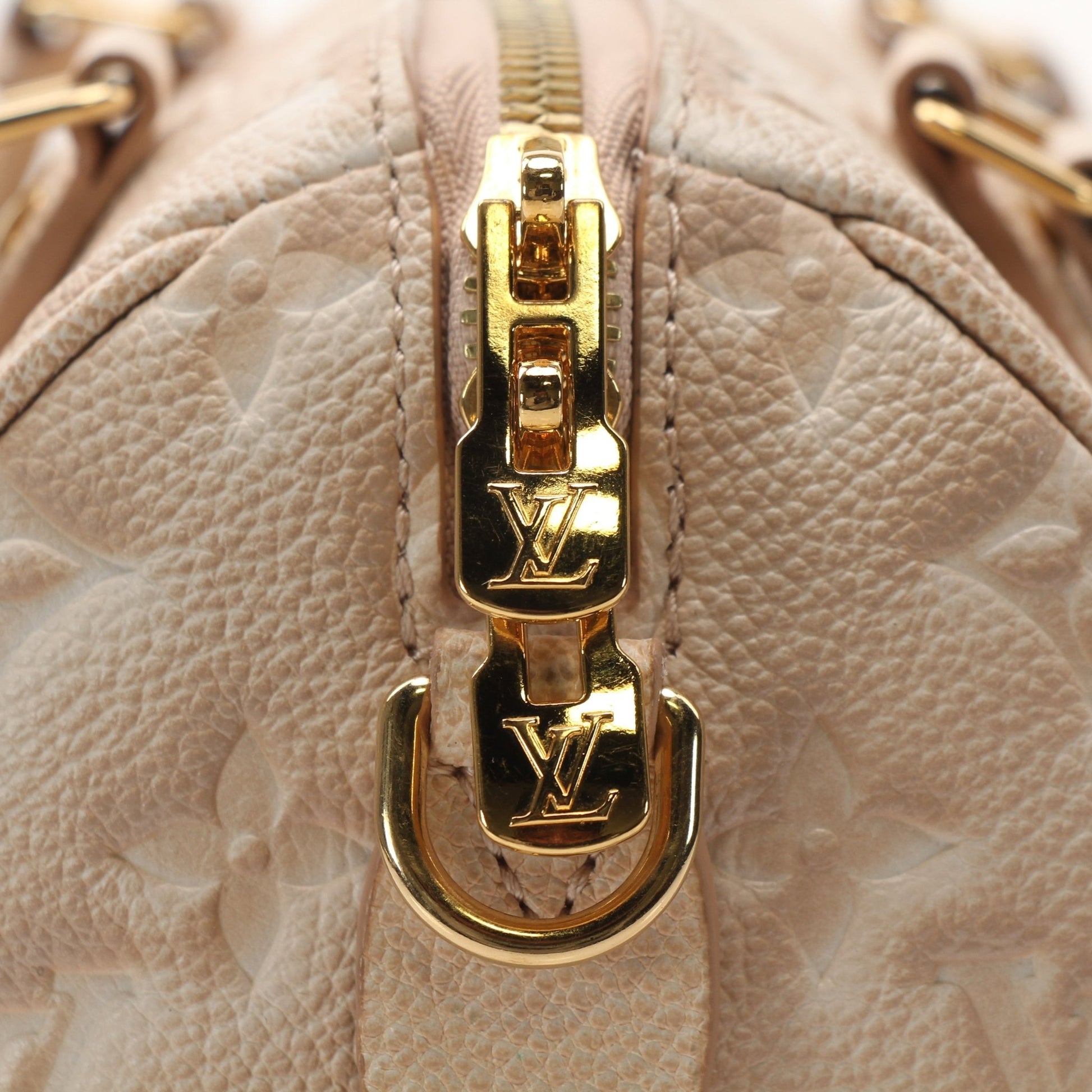 Louis Vuitton Speedy Bandoulière handbag with gold accents, showing the classic monogram canvas and adjustable shoulder strap.