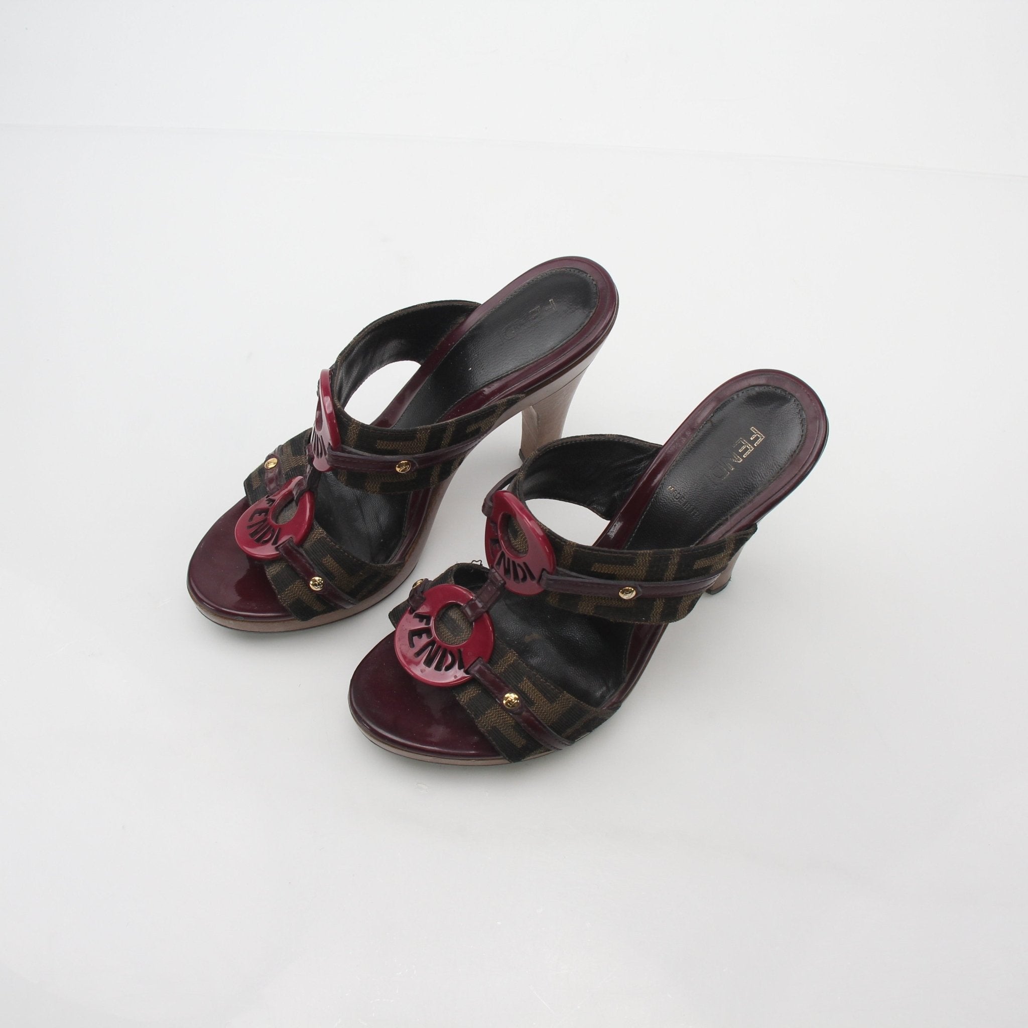 Brown Fendi Zucca canvas platform sandals with chunky heels, featuring the iconic monogram pattern and stylish ankle straps.