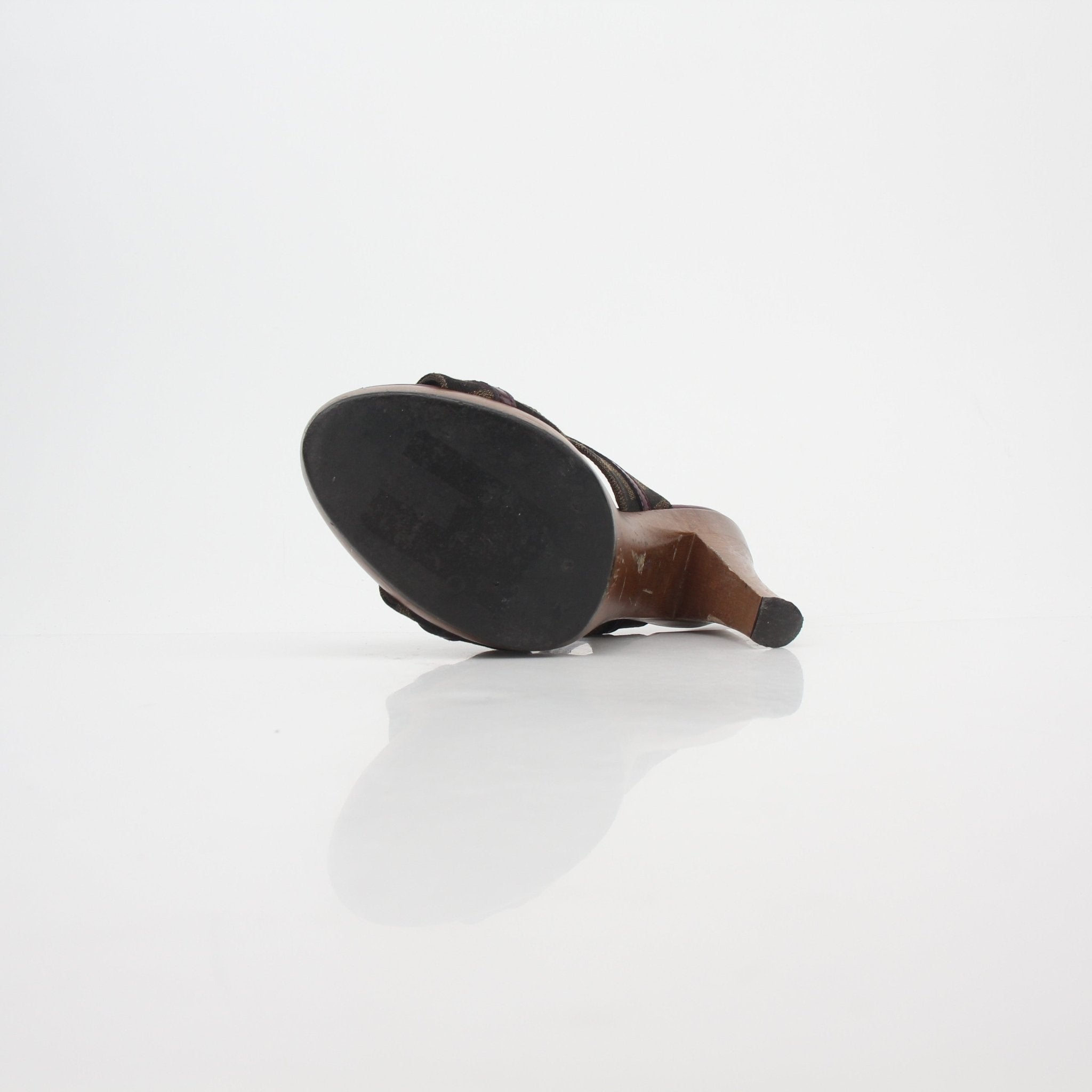 Fendi brown Zucca canvas platform heels with strappy design and chunky sole, showcased on a neutral background.