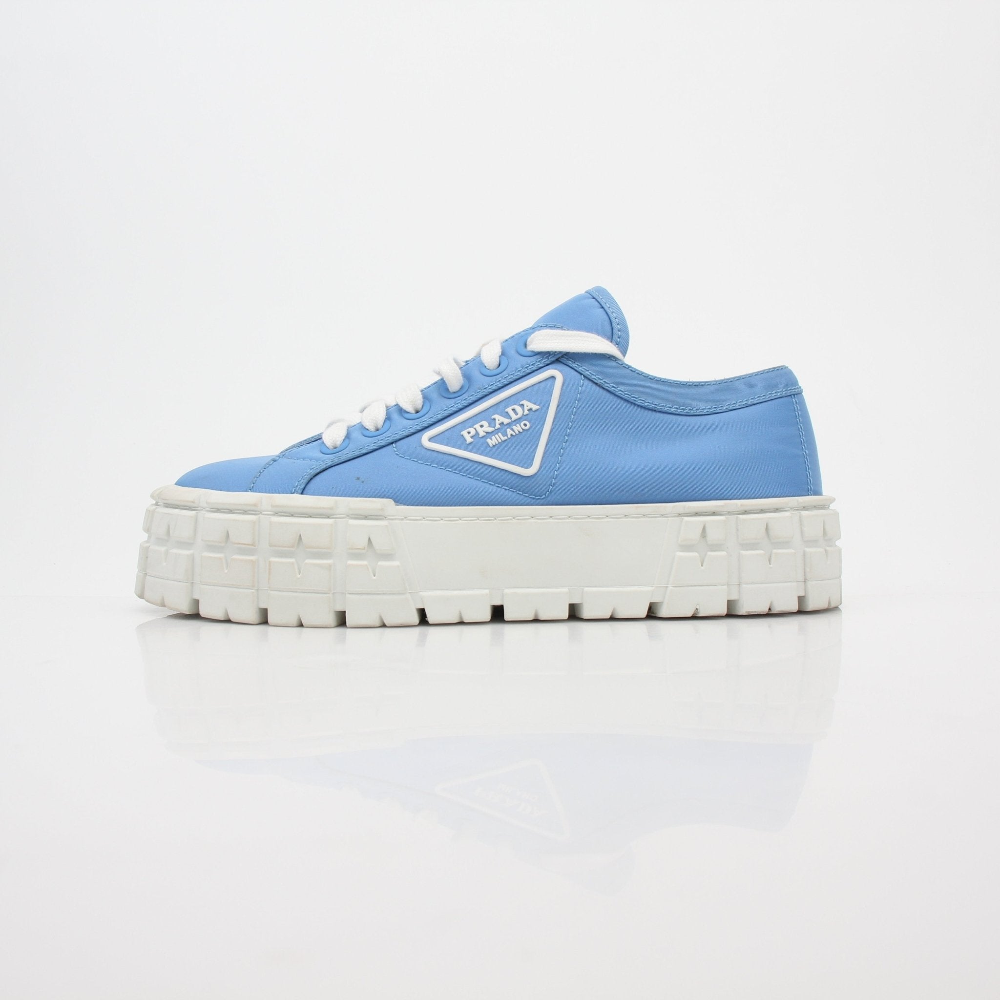 Prada light blue double wheel low top sneakers with white soles and stylish design, perfect for casual wear.