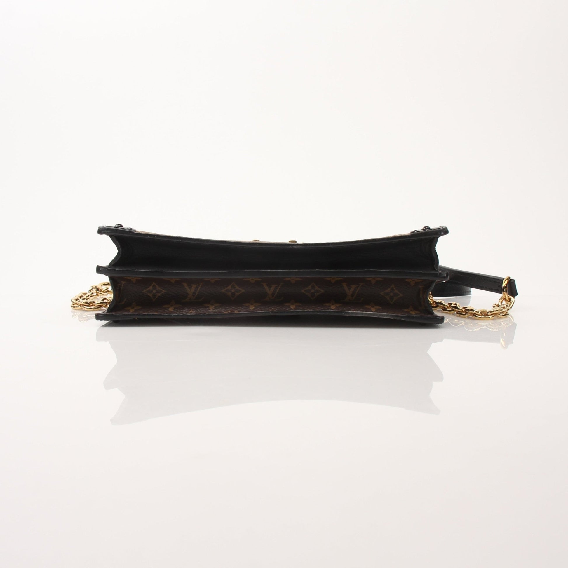 Louis Vuitton Monogram Trunk crossbody handbag with leather strap and gold hardware, showcasing the iconic monogram pattern.