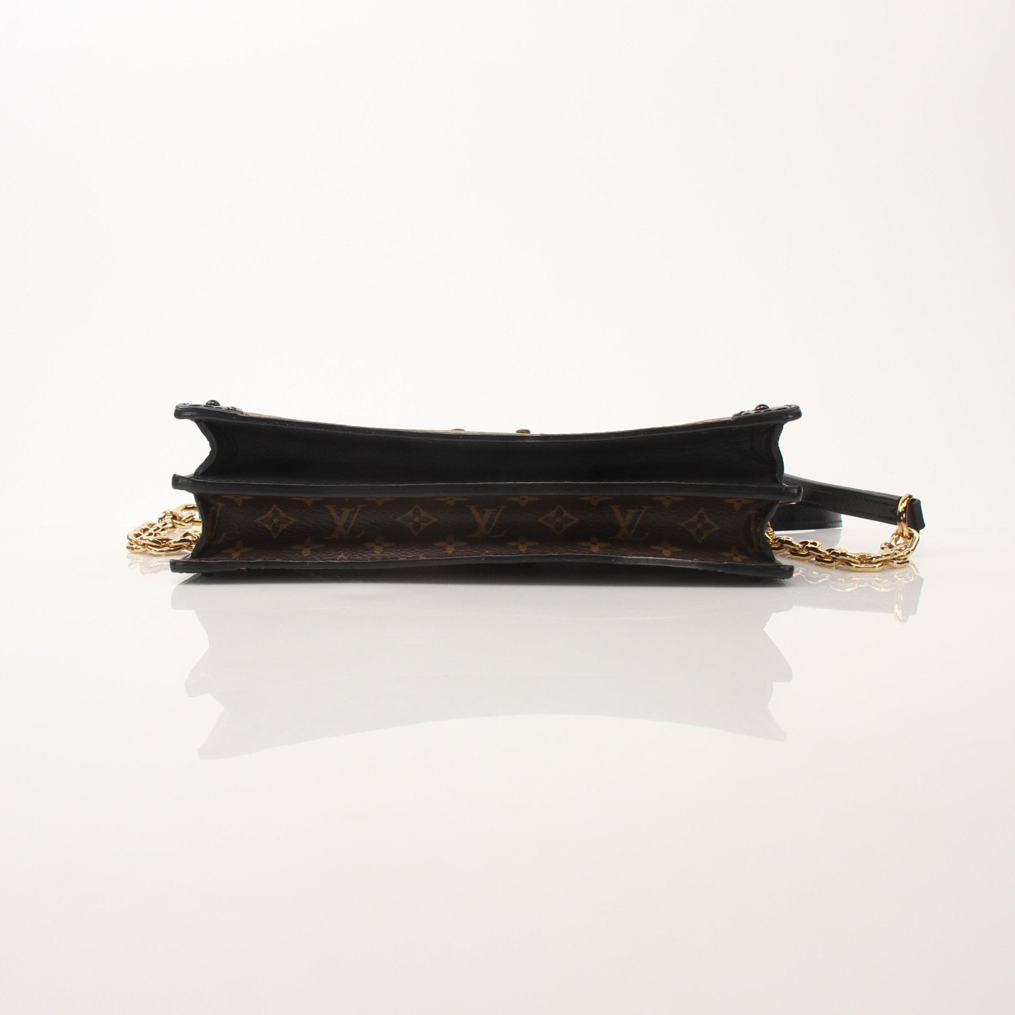 Louis Vuitton Monogram Trunk crossbody handbag with leather strap and gold hardware, showcasing the iconic monogram pattern.