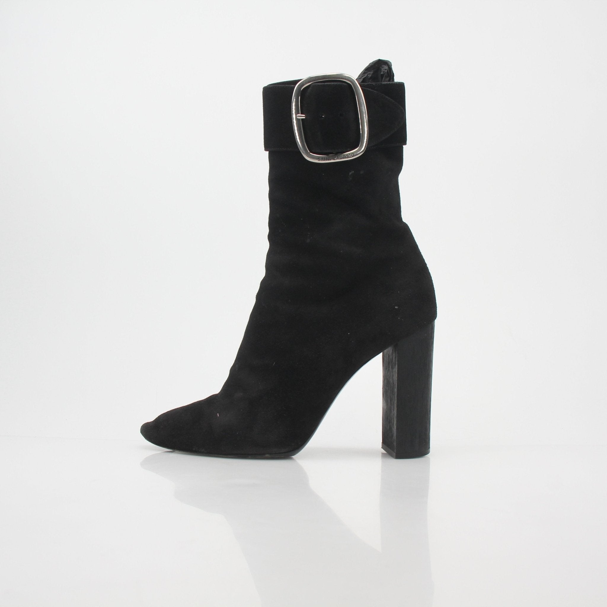 Black suede Saint Laurent Joplin buckle ankle boots with pointed toes and block heels, displayed on a neutral background.