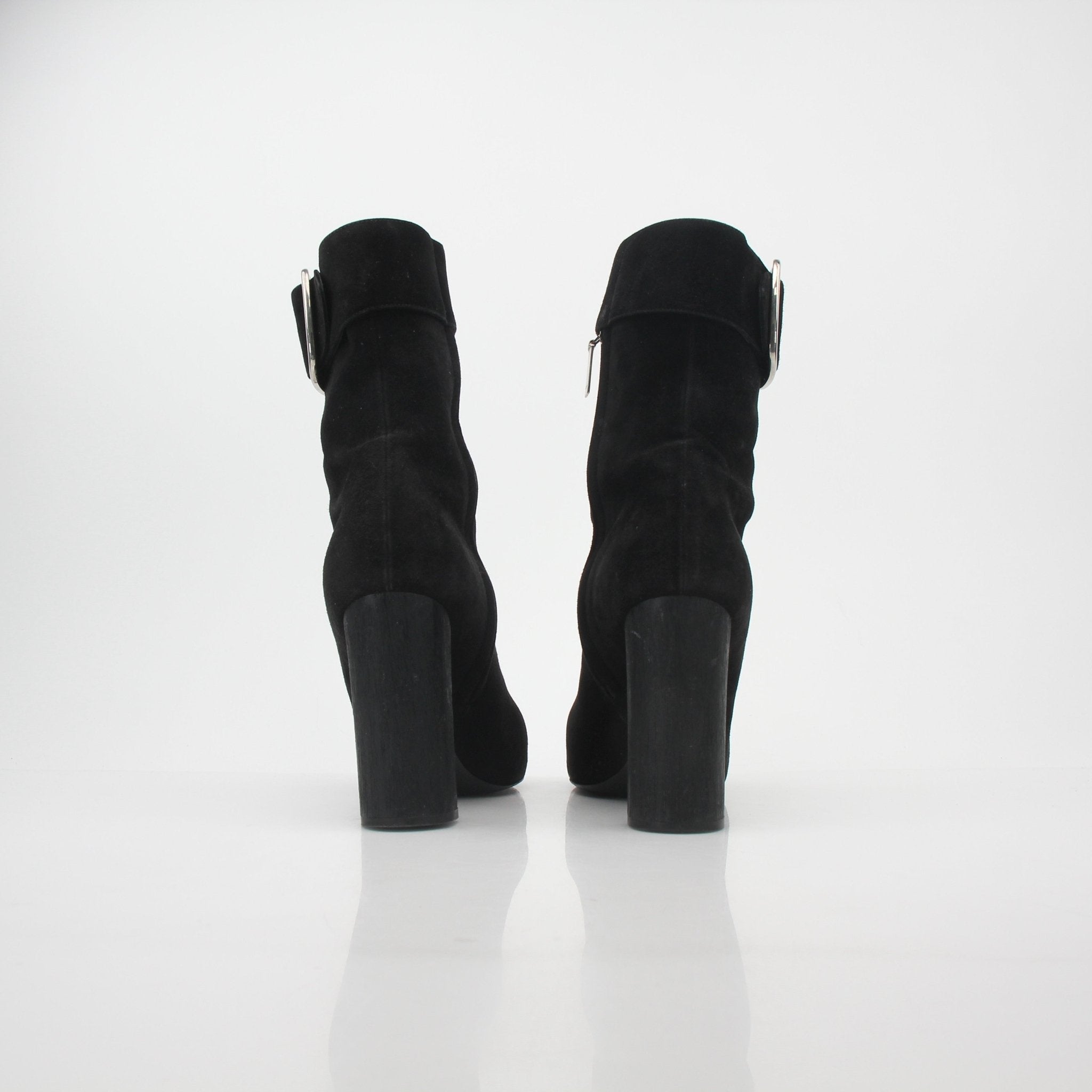 Black suede Saint Laurent Joplin buckle ankle boots with gold accents, stylish shoes displayed on a neutral background.