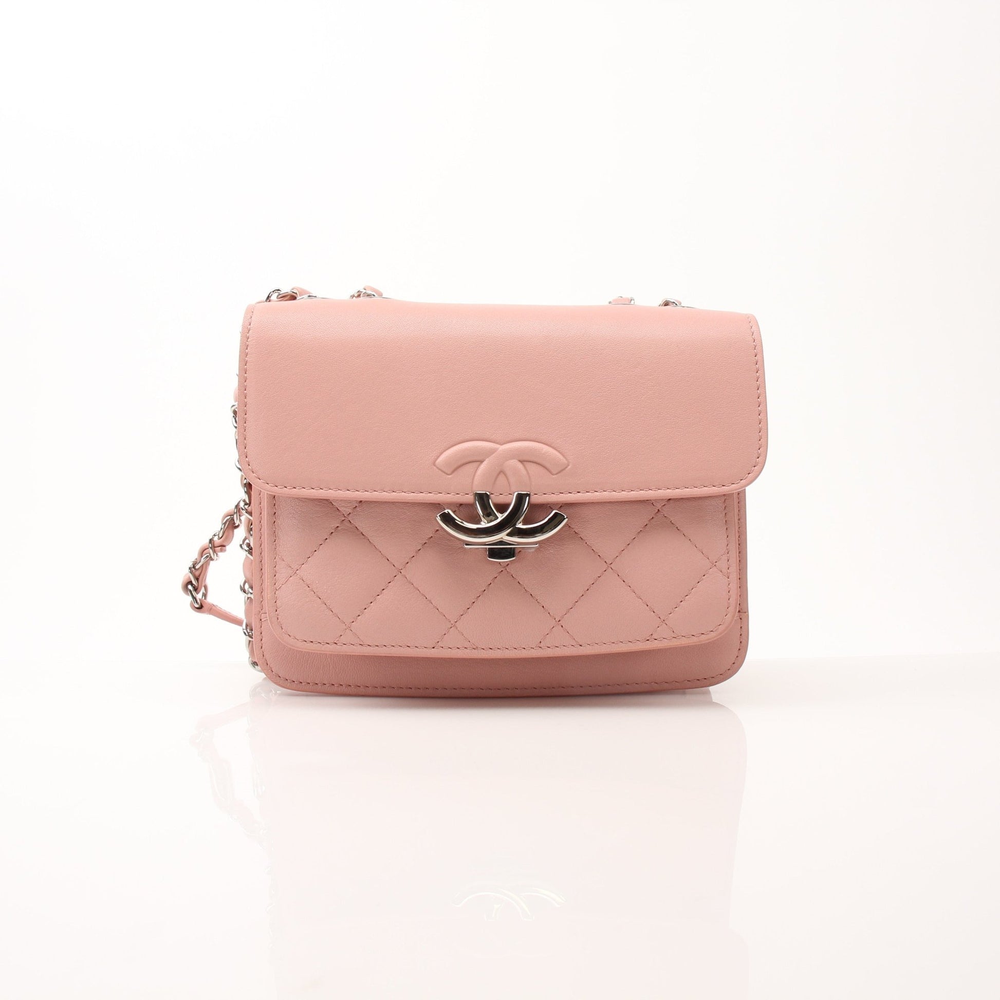 Chanel pink CC box flap shoulder handbag with gold chain strap and classic quilting detail.