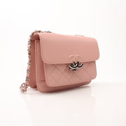 Chanel pink CC box flap shoulder handbag with gold hardware, featuring a stylish leather design and chain strap.