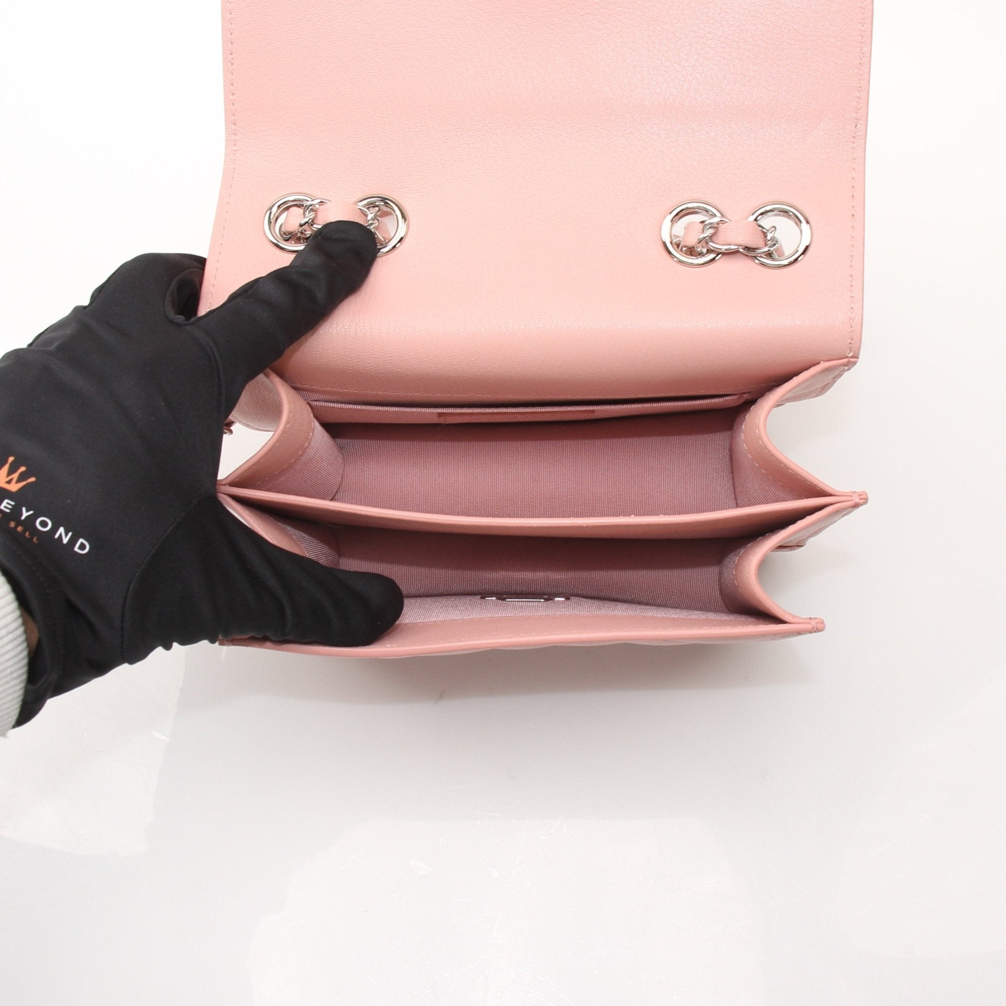 Chanel pink CC box flap shoulder handbag with gold chain strap and signature logo, displayed on a neutral background.