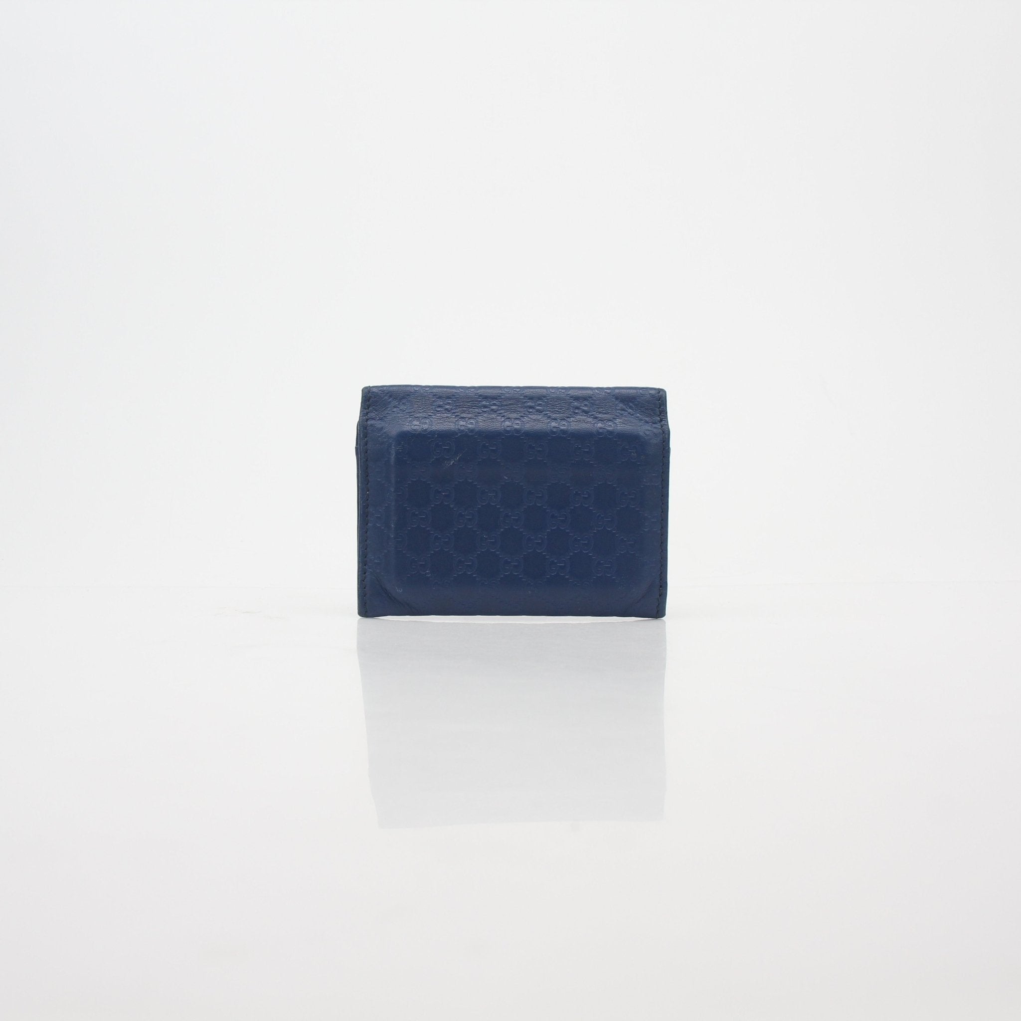 Blue Gucci Micro Guccissima leather flap card case wallet with gold accents, featuring signature pattern and compact design.