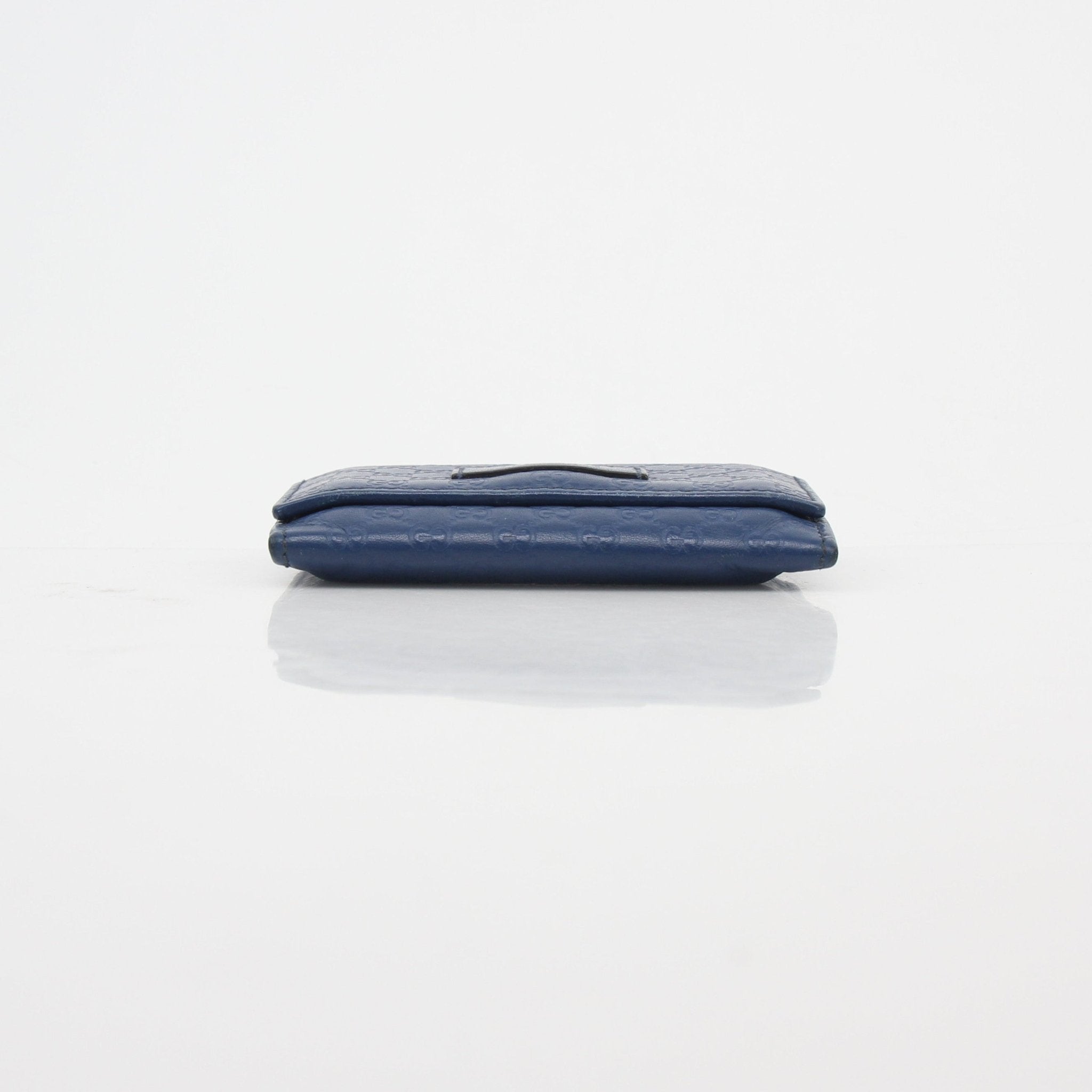 Gucci blue Micro Guccissima leather flap card case wallet with compact design and gold-tone accents, crafted by Gucci.
