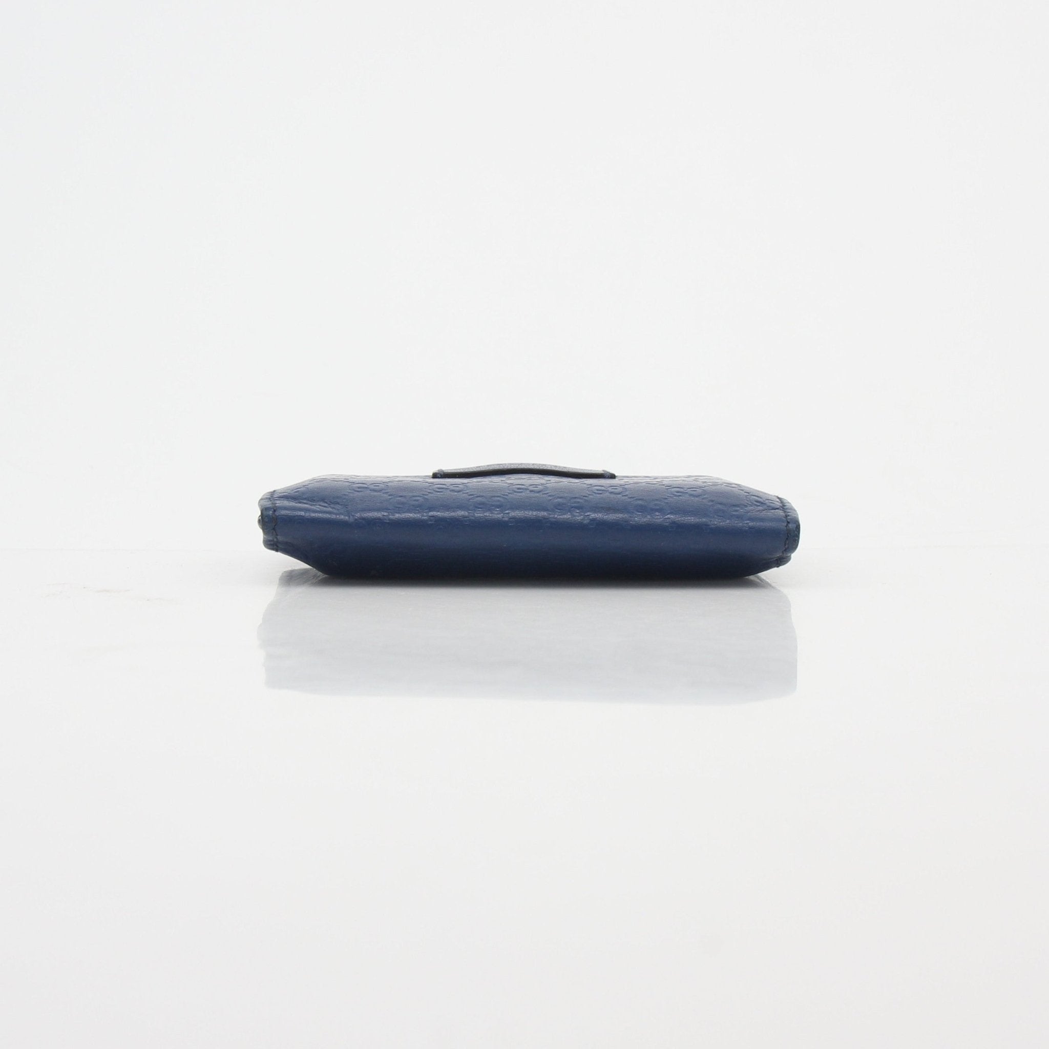 Gucci blue micro Guccissima leather flap card case wallet with gold accents, compact and stylish for holding cards.