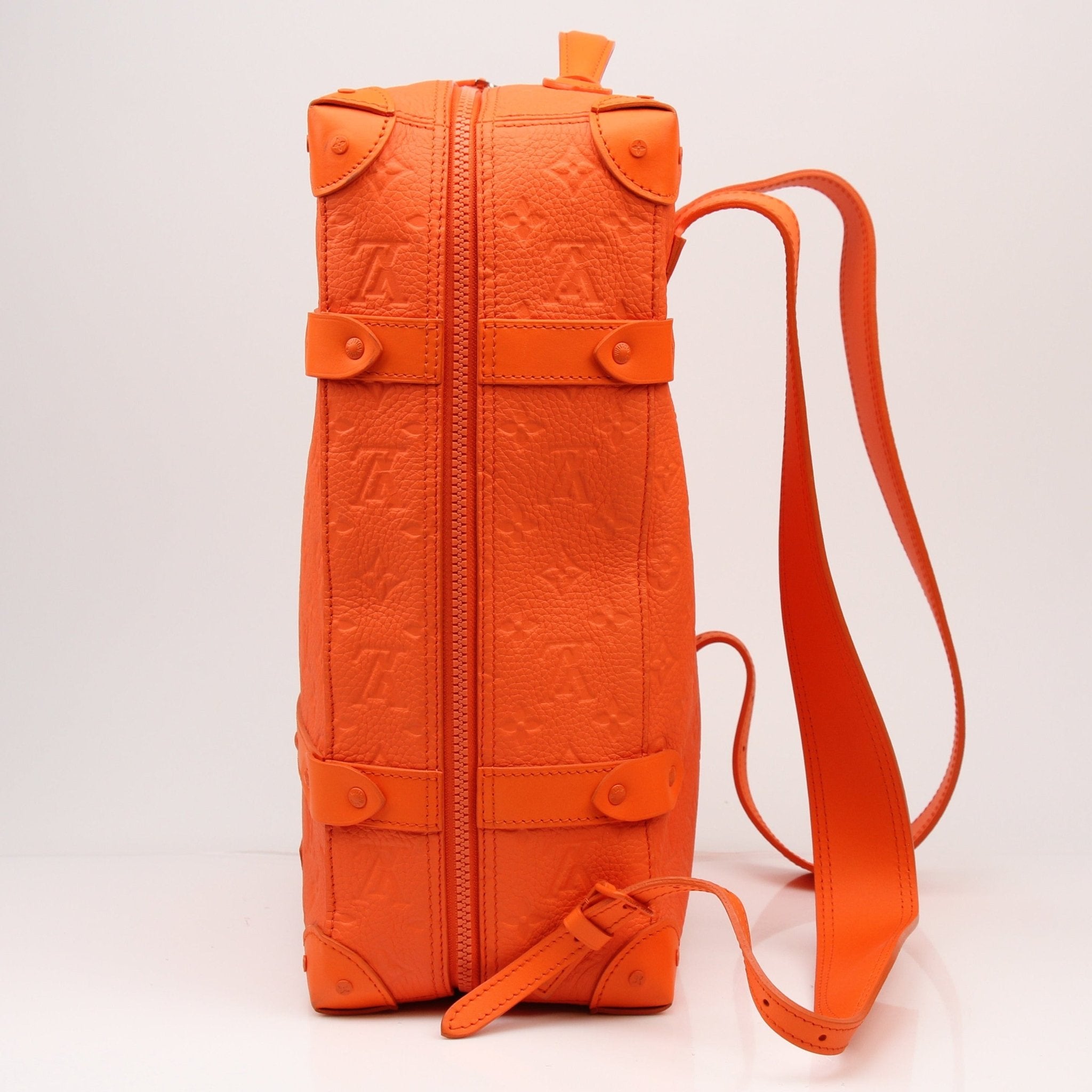 Gold & Beyond Louis Vuitton Christopher PM backpack, stylish travel bag in premium materials, showing front view and handle details.