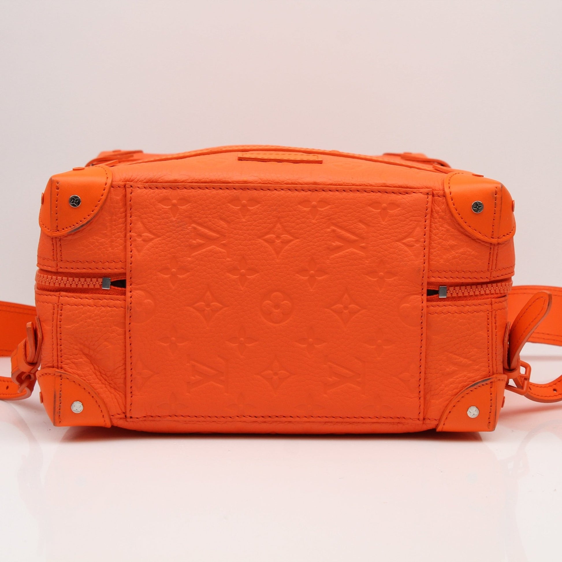 Louis Vuitton Christopher PM backpack, a stylish travel bag with monogram canvas and leather trim, shown in a natural setting.
