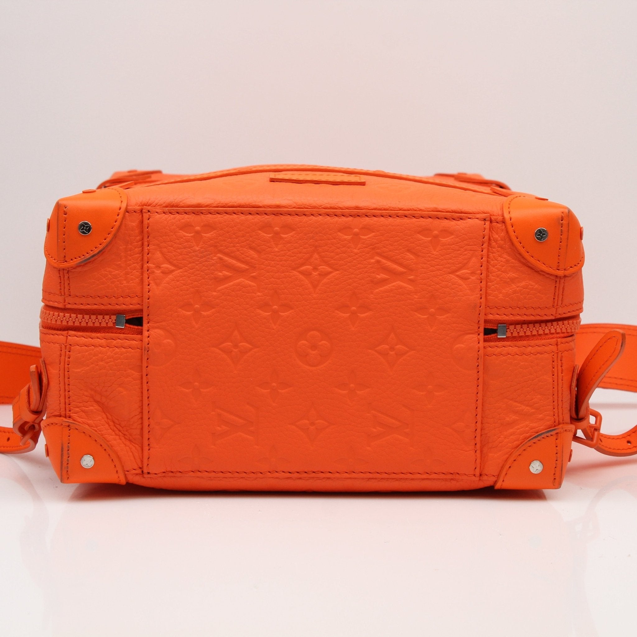 Louis Vuitton Christopher PM backpack, a stylish travel bag with monogram canvas and leather trim, shown in a natural setting.