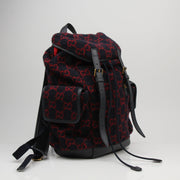 Gucci GG Monogram backpack handbag with gold accents and adjustable straps, featuring the iconic monogram pattern.