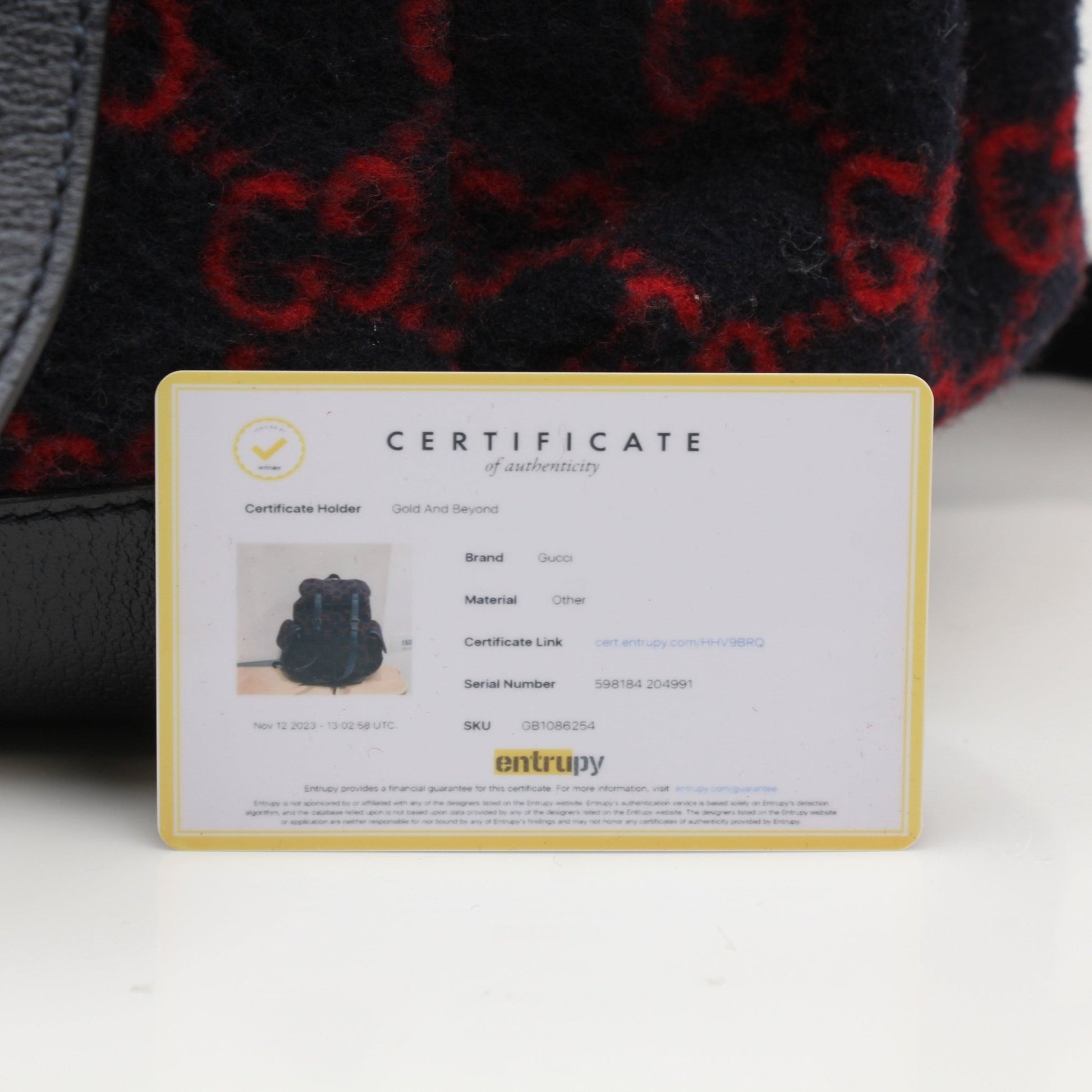 Gucci GG Monogram backpack in black leather with gold-tone hardware, featuring adjustable straps and signature monogram pattern.