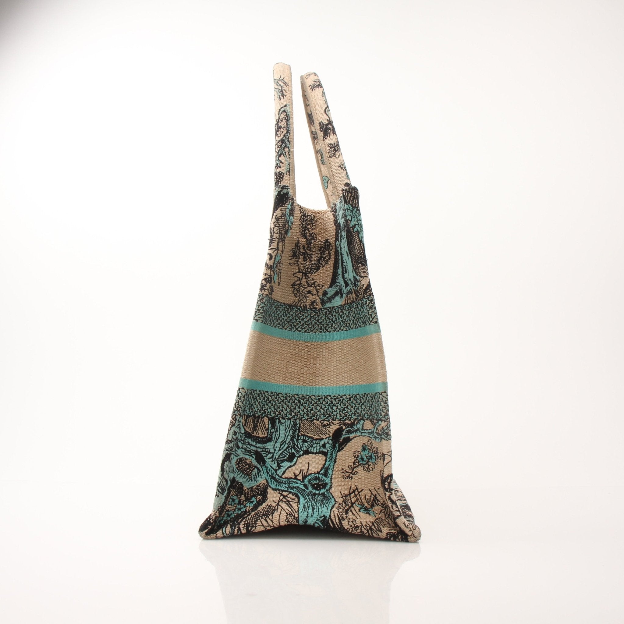 Christian Dior Book Tote handbag with floral pattern and top handles, shown in natural beige fabric with brown leather accents.