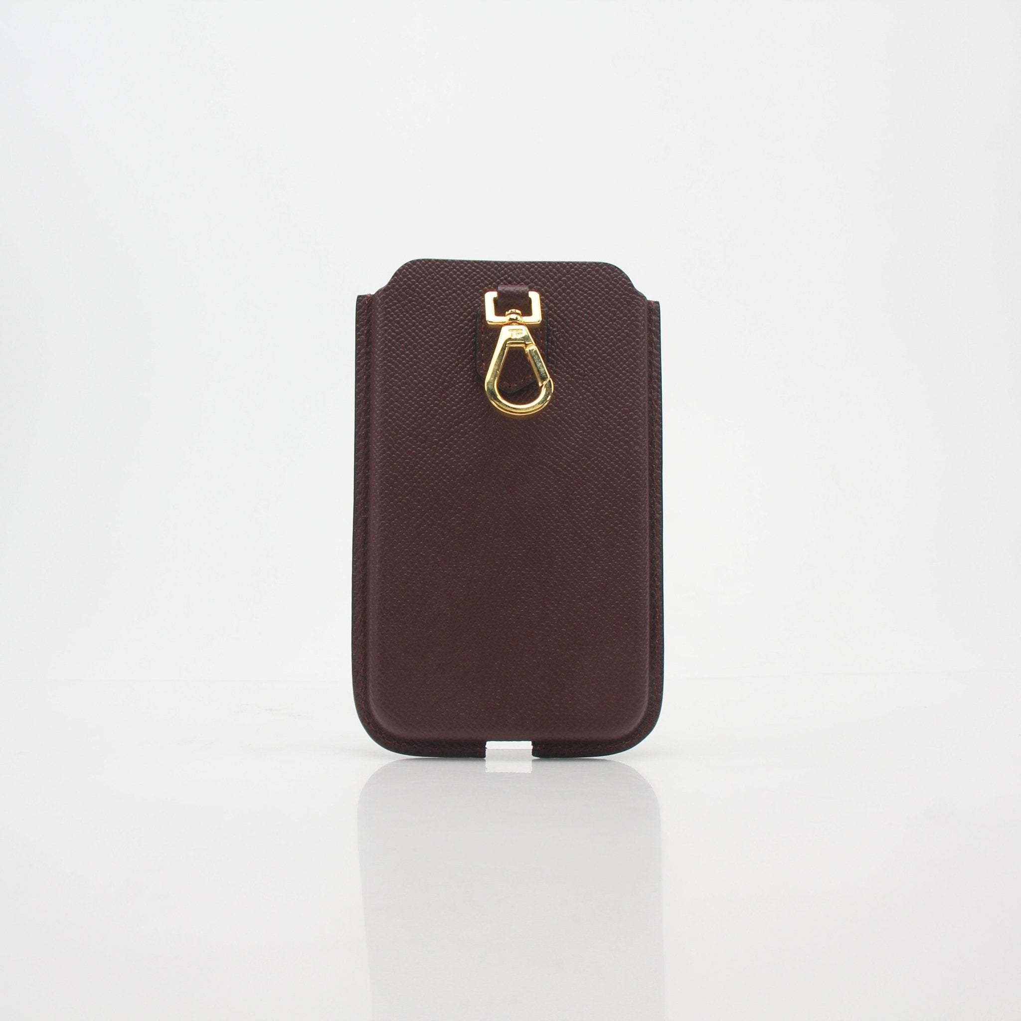 Tom Ford burgundy leather phone case with attached lanyard, designed for hand-held use and stylish protection.