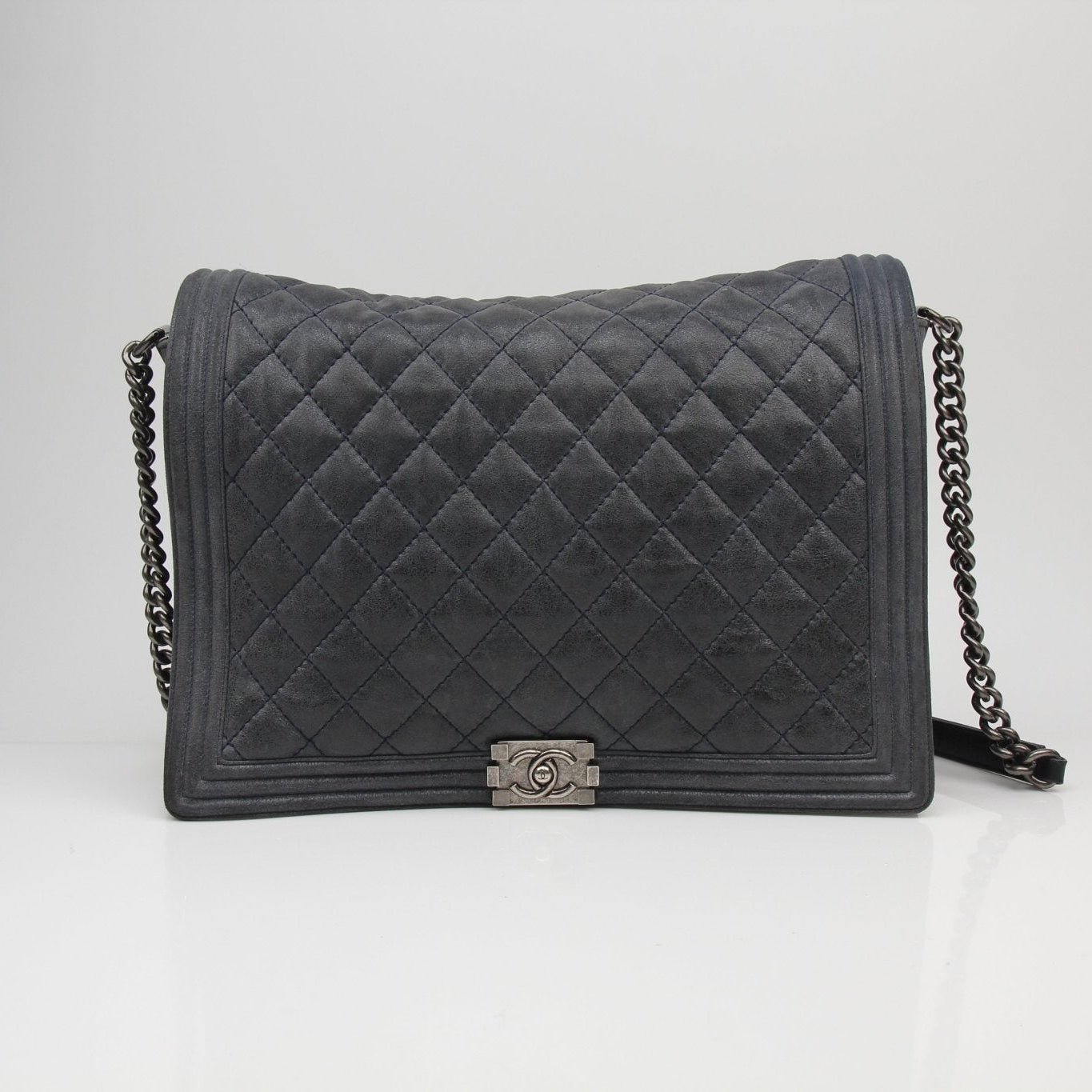 Gold & Beyond Chanel Charcoal large quilted soft boy handbag with chain strap and signature stitching detail.