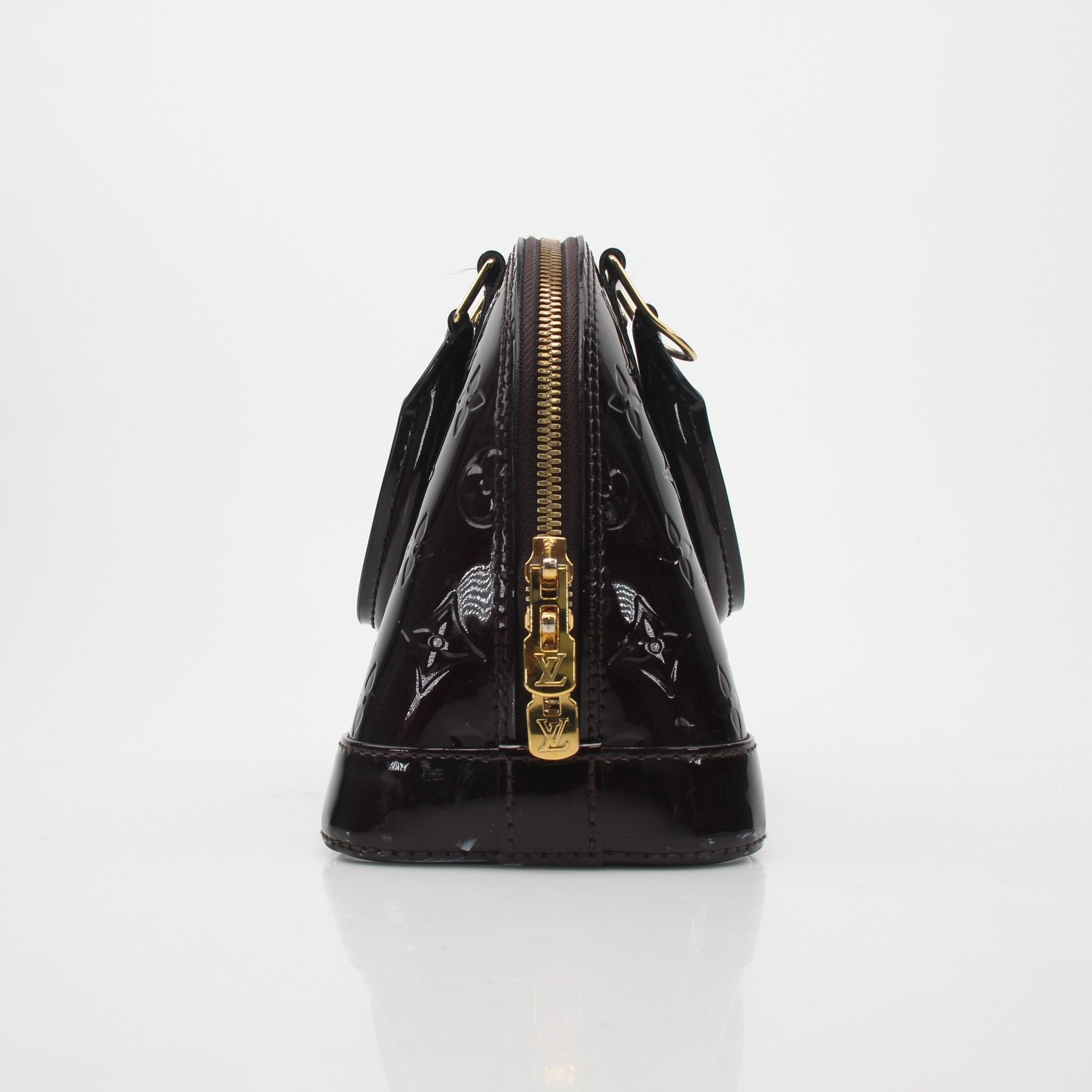 Louis Vuitton Monogram Vernis Alma BB handbag with gold-tone hardware and structured shape, featuring shiny monogram leather.