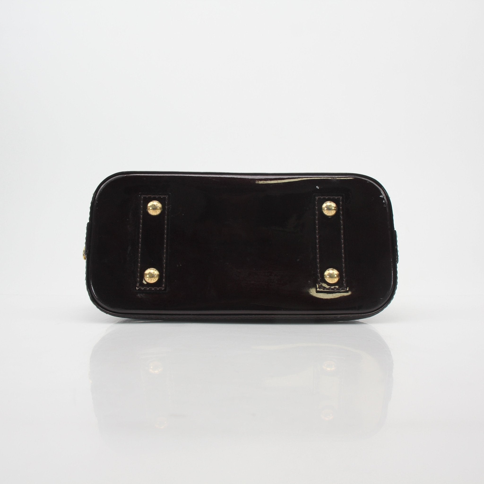 Louis Vuitton Monogram Vernis Alma BB handbag in gold with shiny patent finish and structured shape, featuring top handles and gold hardware.