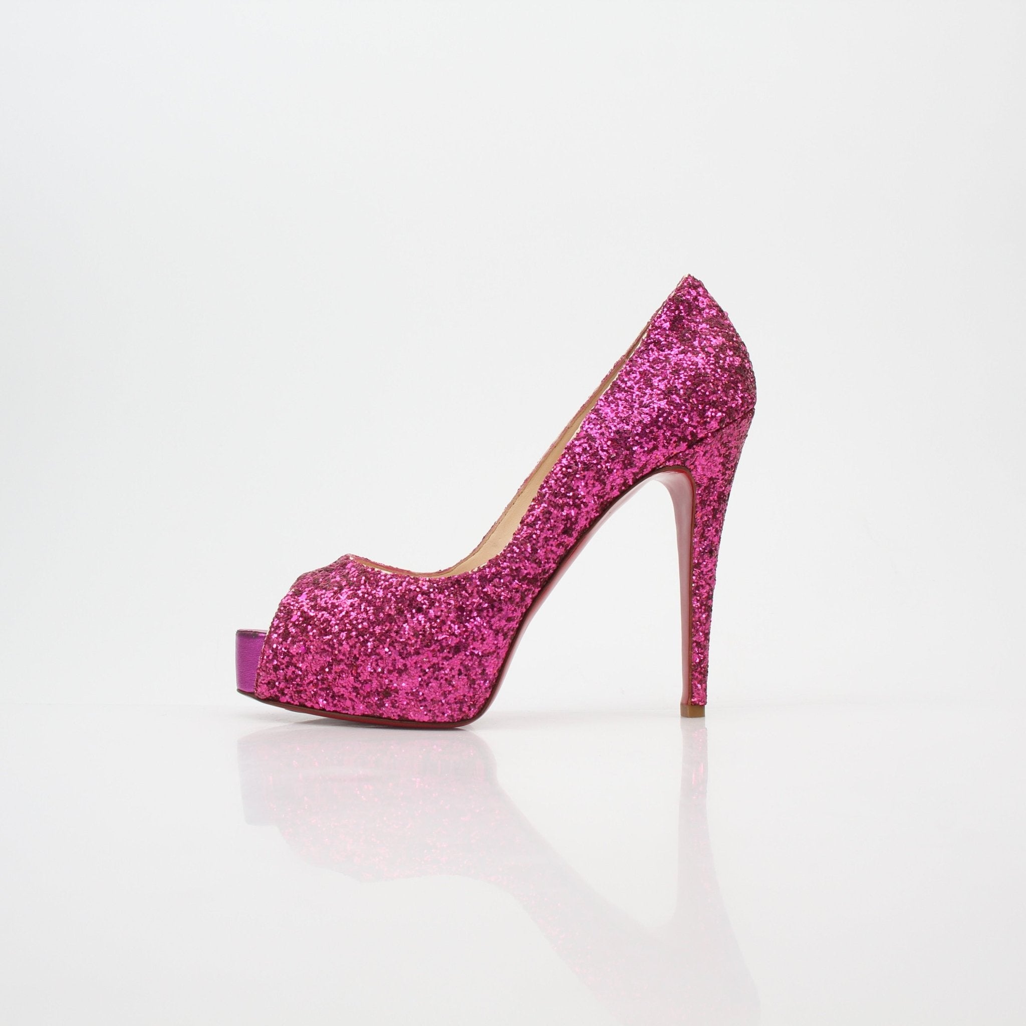 Gold & Beyond Christian Louboutin pink glitter Very Privé platform heels with tall stiletto heels and glittery finish.