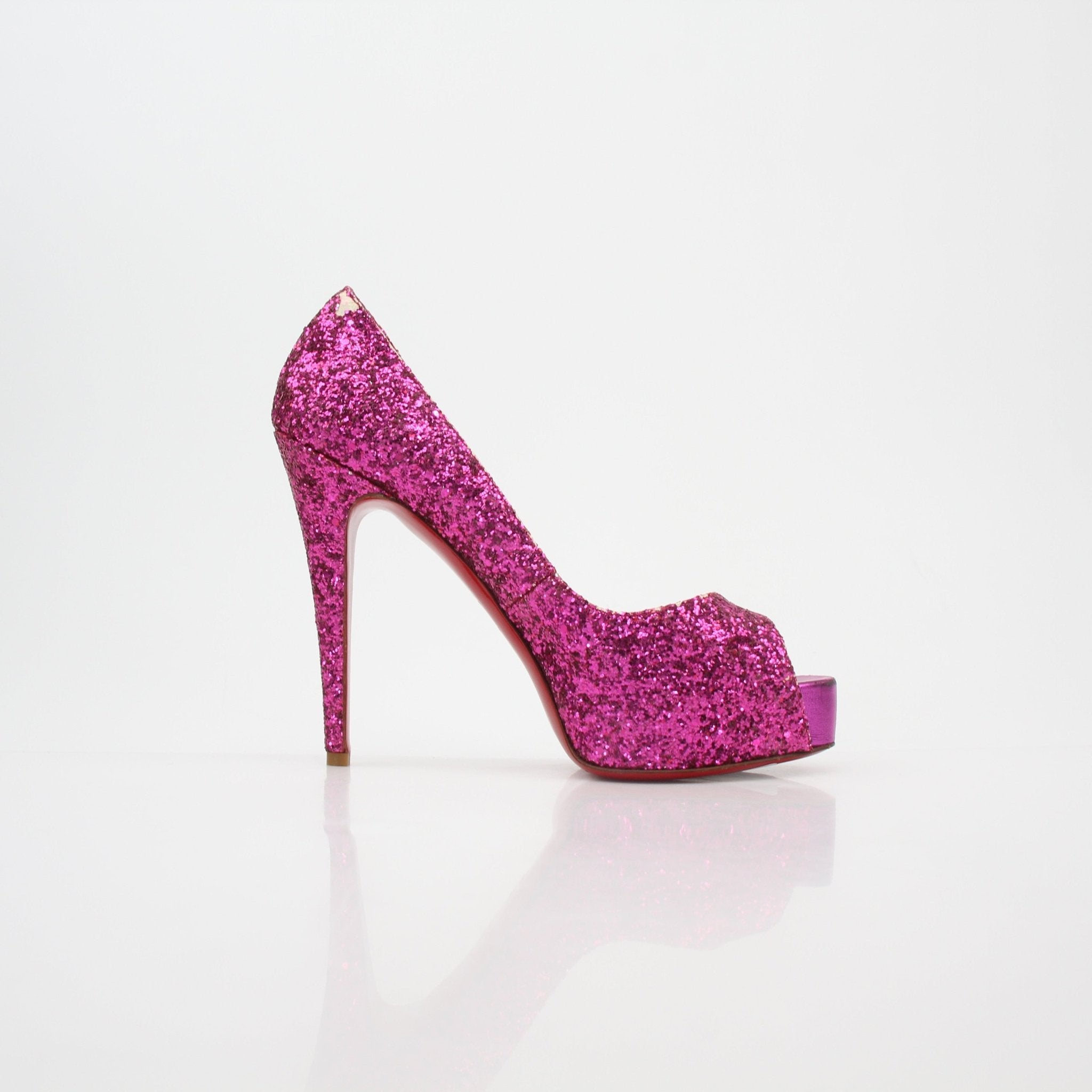 Pink glitter Christian Louboutin Very Privé platform heels with stiletto design and high heel, displayed on a neutral background.