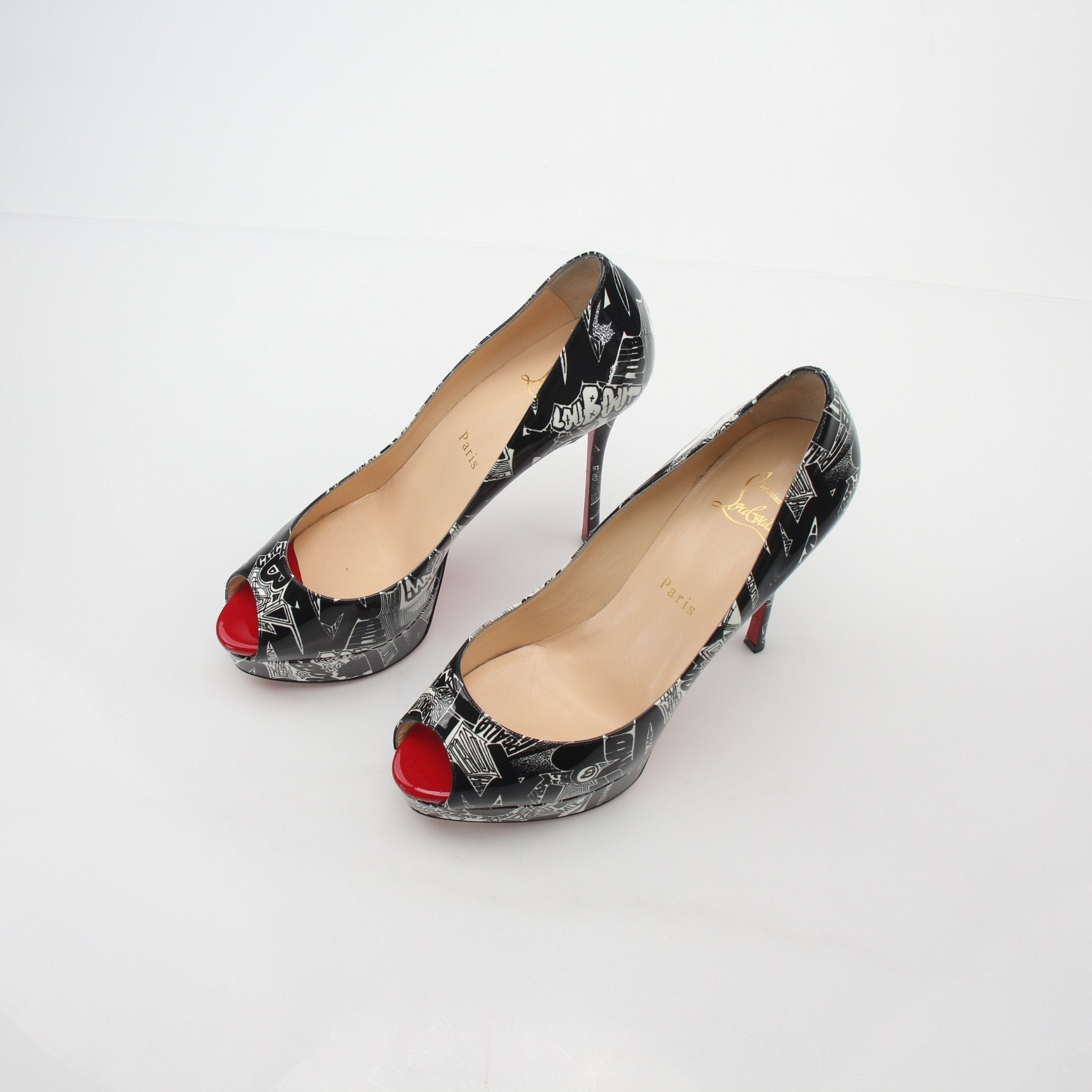 Christian Louboutin black and white printed fetish peep platform heels with high stiletto heels and bold design.