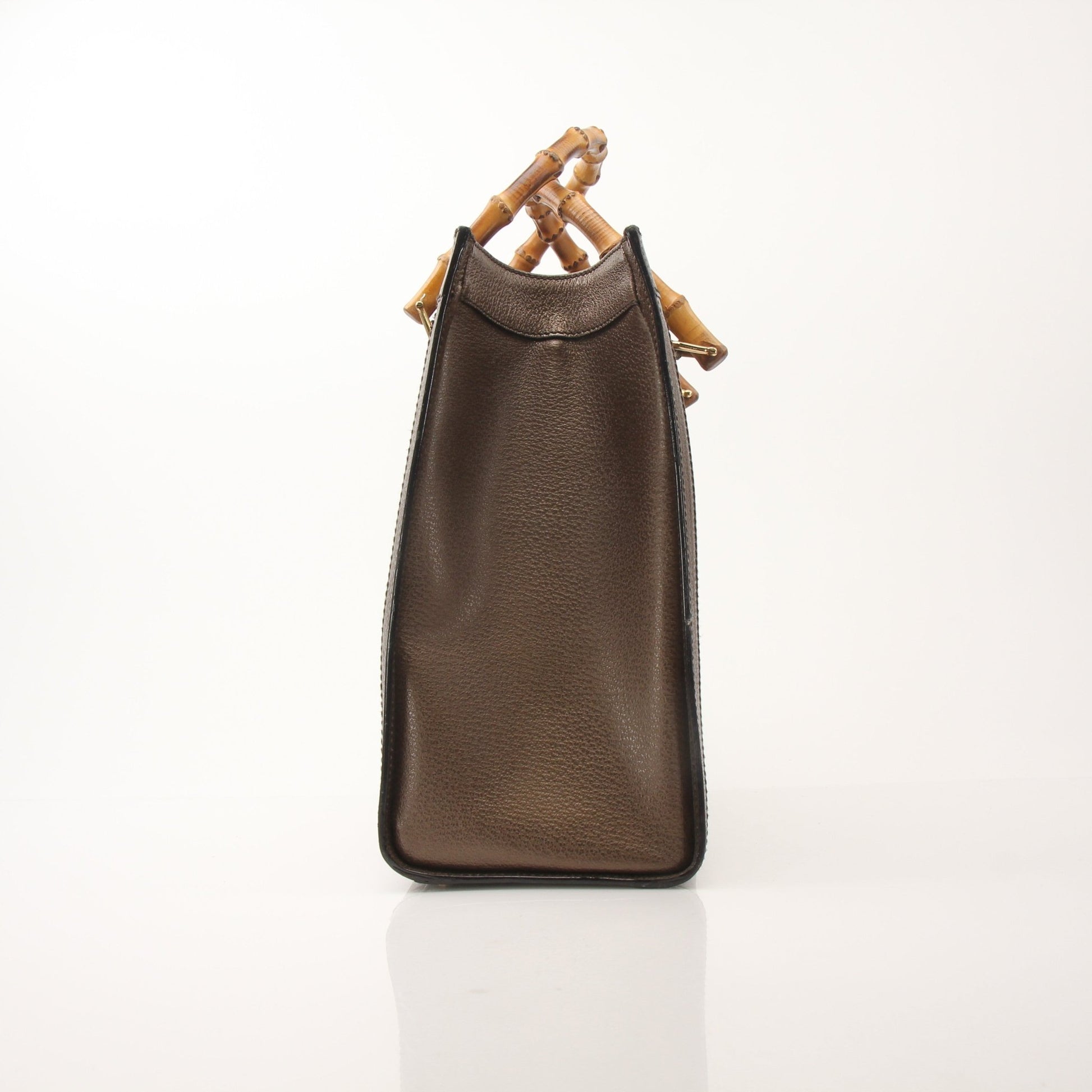 Gold & Beyond Gucci Bamboo Tote handbag with beige woven bamboo body and tan leather handles, front logo plaque, and spacious interior.