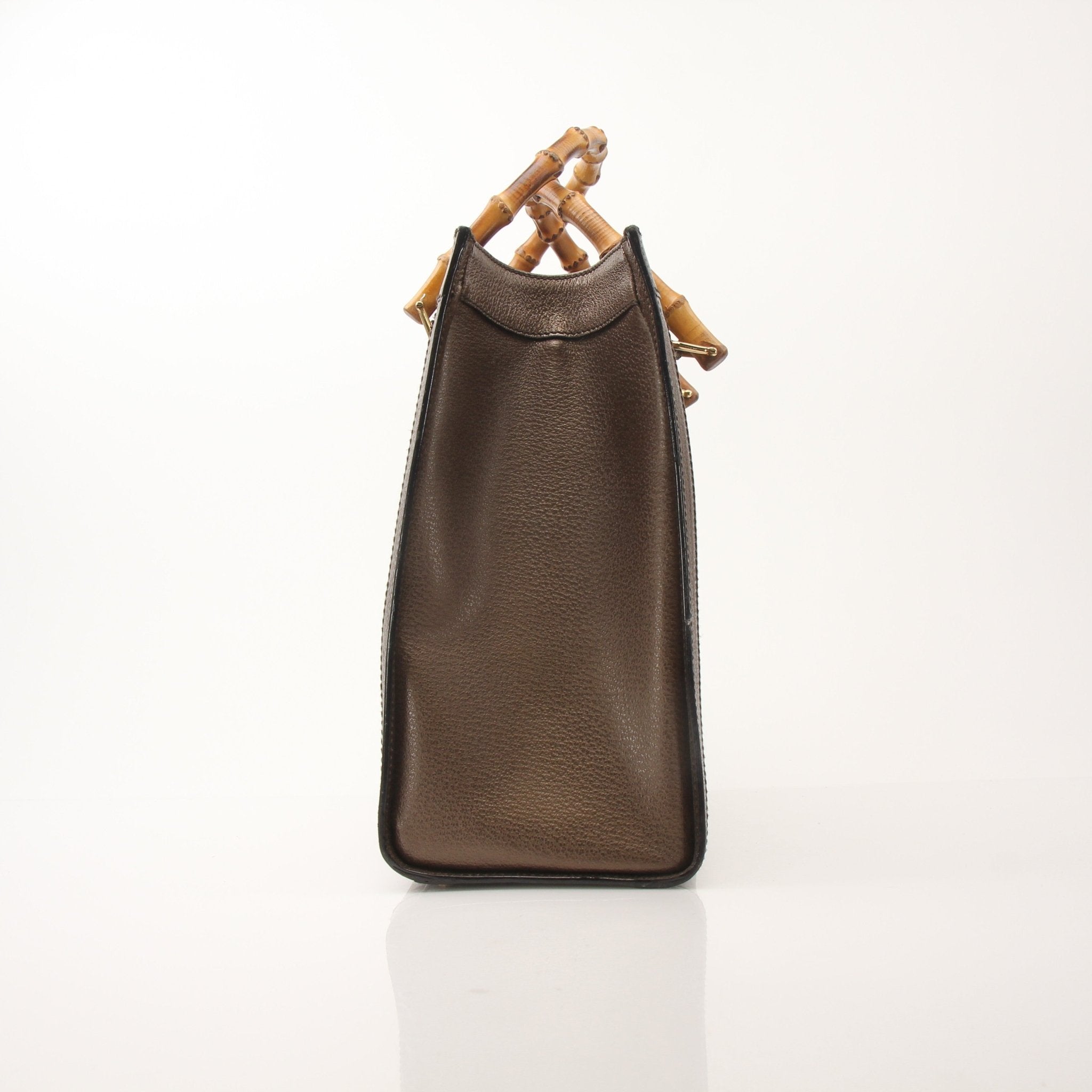 Gold & Beyond Gucci Bamboo Tote handbag with beige woven bamboo body and tan leather handles, front logo plaque, and spacious interior.