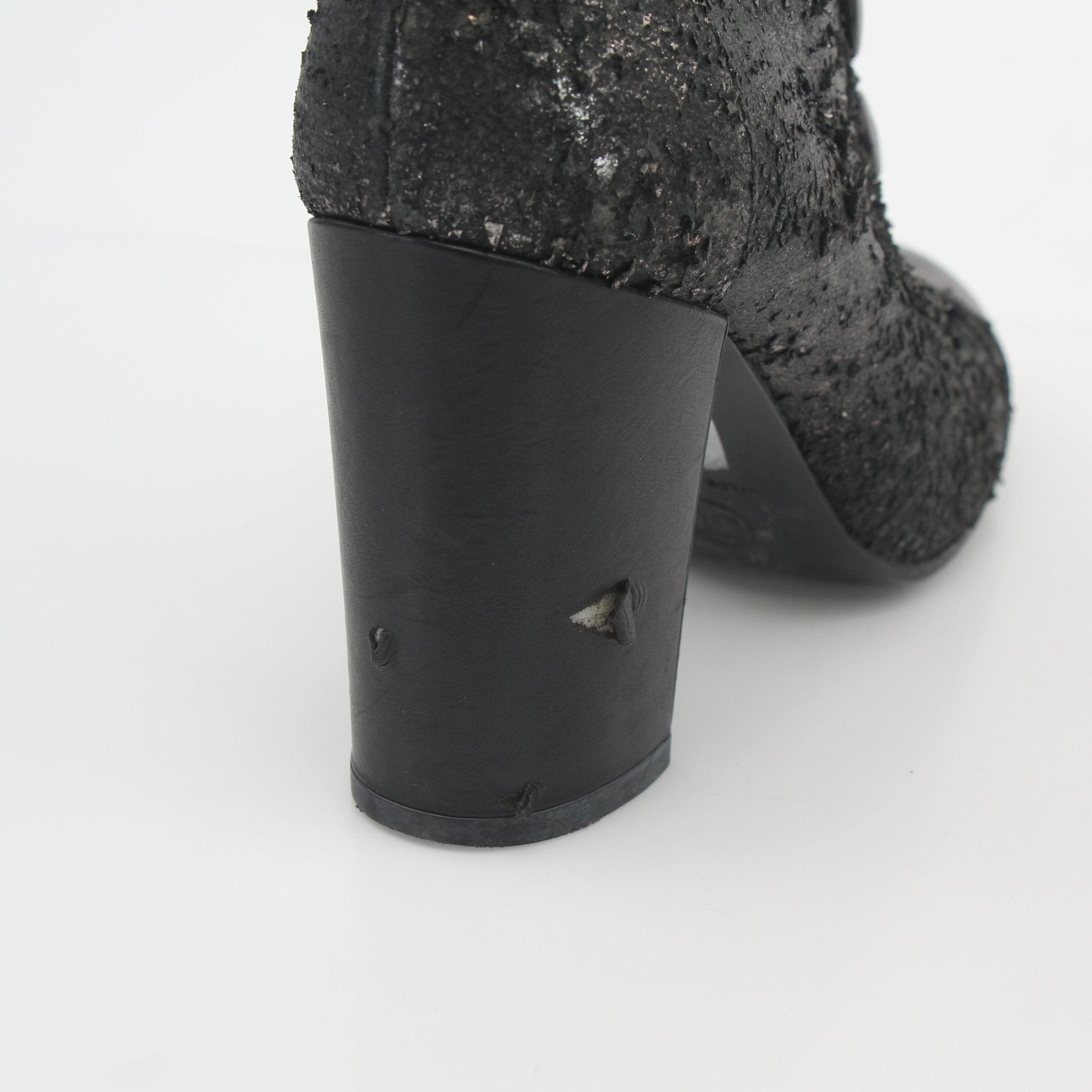 Gold & Beyond Chanel black distressed cutout ankle boots, stylish shoes with edgy design and ankle-high silhouette.